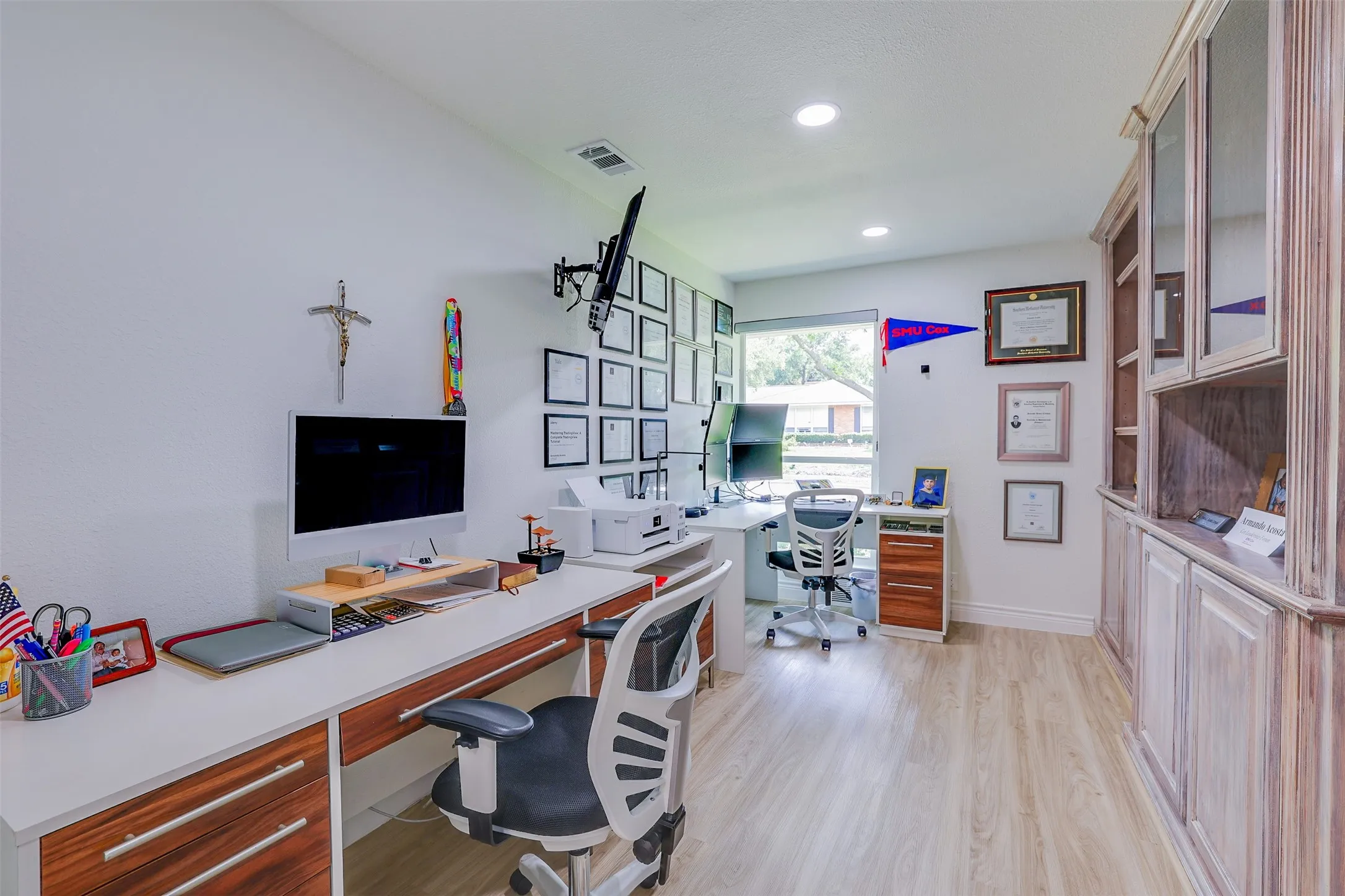 Bright room featuring light wood-finish flooring, recessed lighting, and a large window