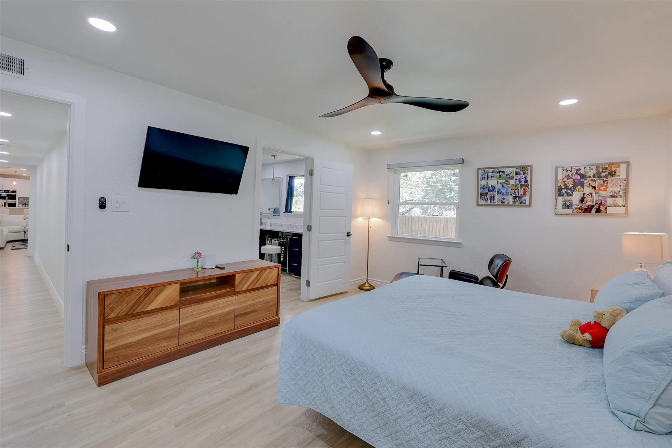 Spacious interior featuring light wood-finish flooring, recessed lighting, and a contemporary ceiling fan
