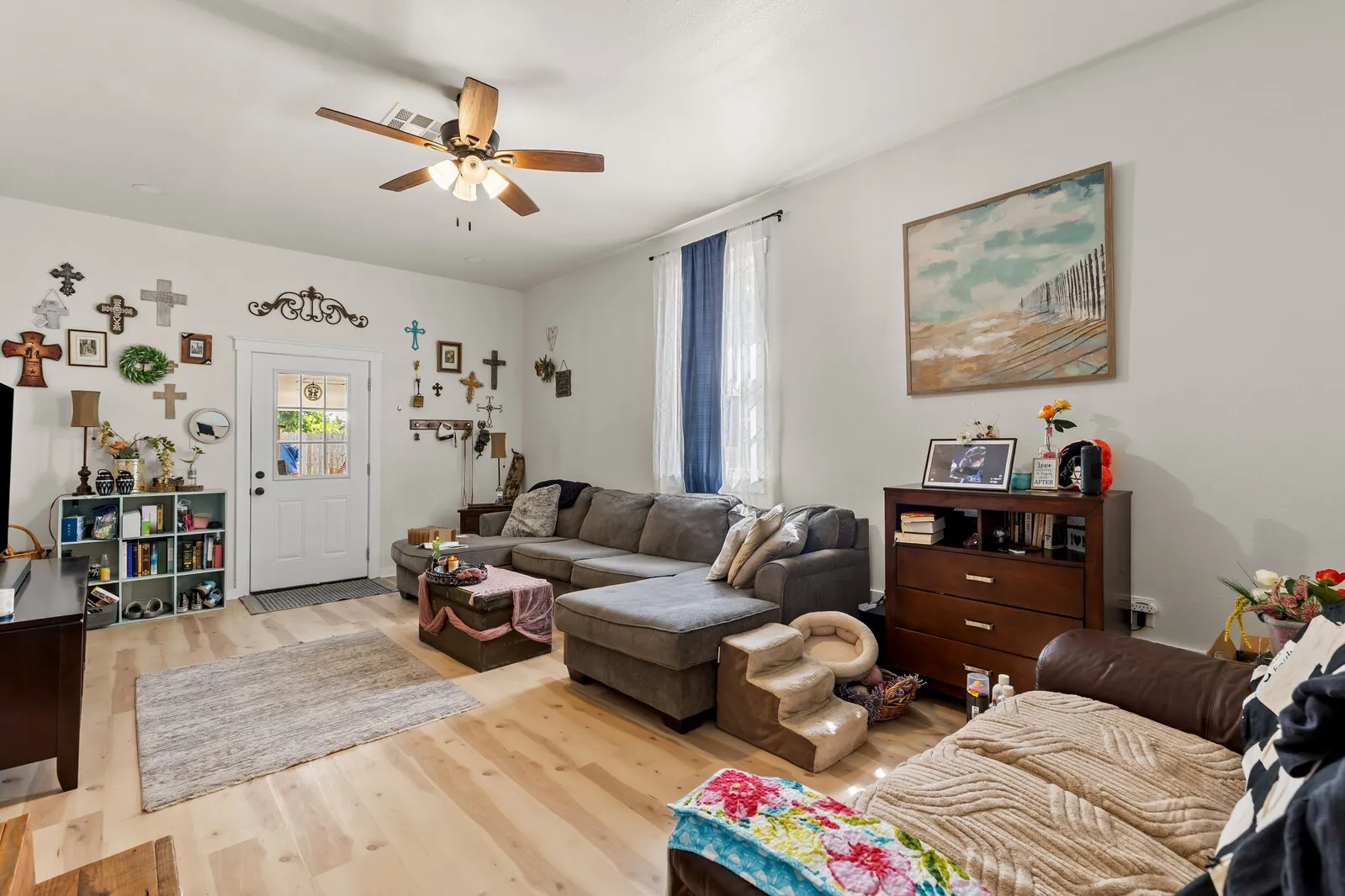 Light wood-finish flooring complements the neutral wall color in this living area