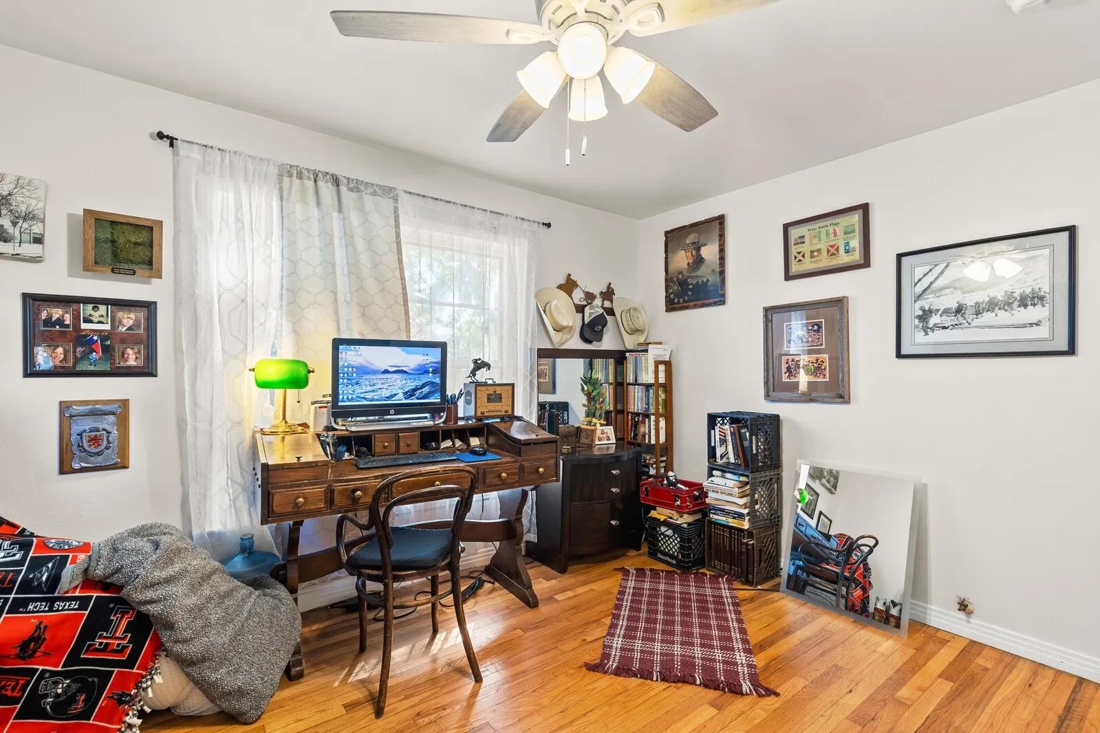 Hardwood flooring and a ceiling fan with integrated lighting