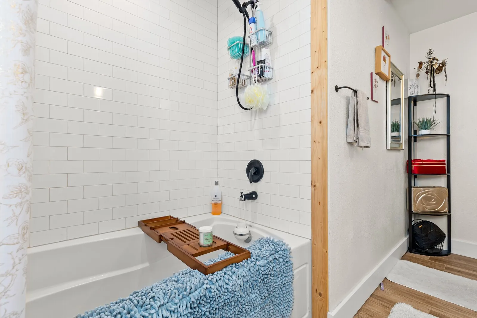 Bathtub with subway tile surround and matte black fixtures