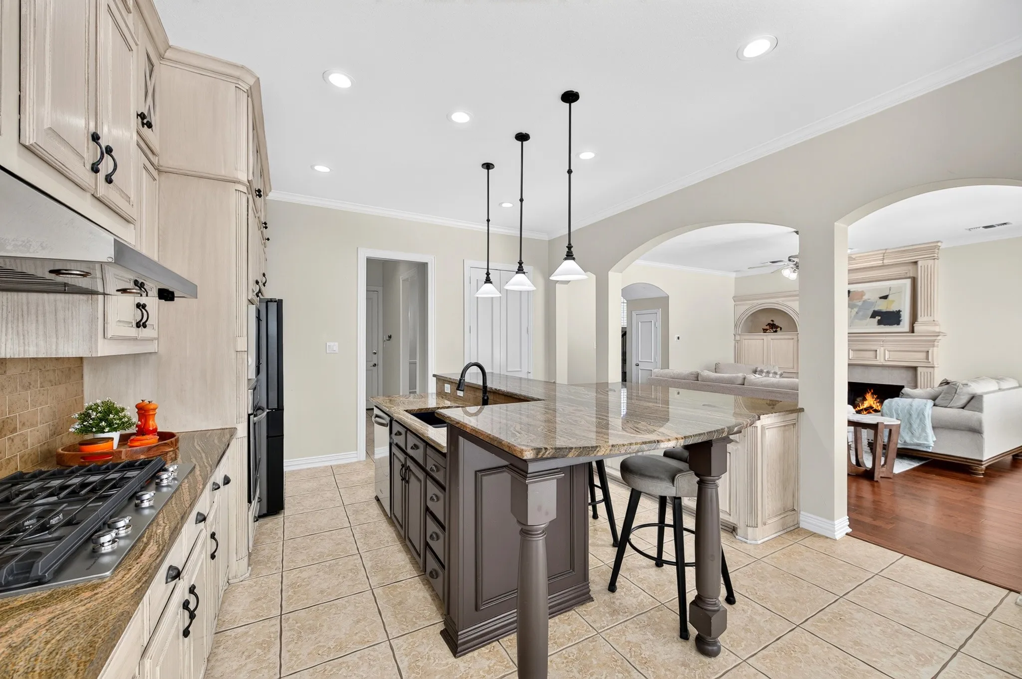 Kitchen featuring an island with seating, a built-in sink, and pendant lighting
