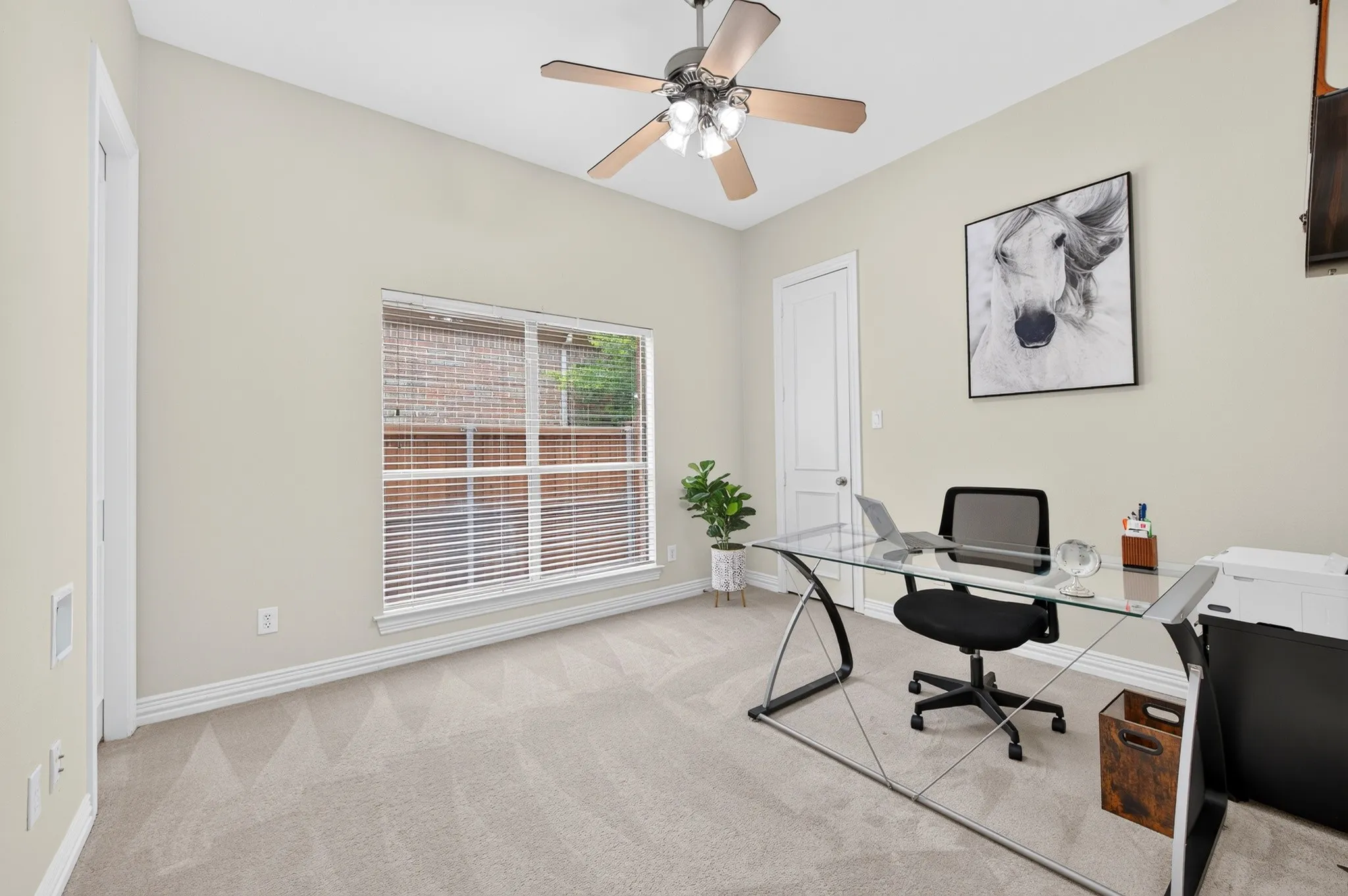 Room featuring neutral wall tones, textured carpeting, and a window with horizontal blinds