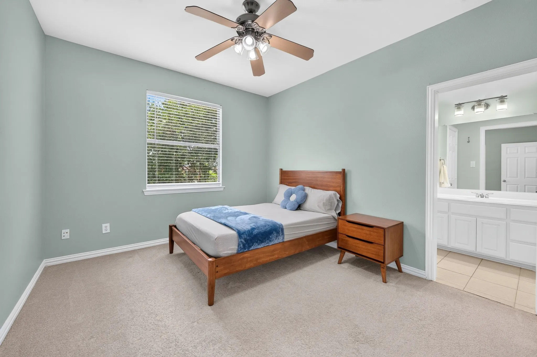 Light blue bedroom featuring a window with blinds, a ceiling fan, and carpet flooring