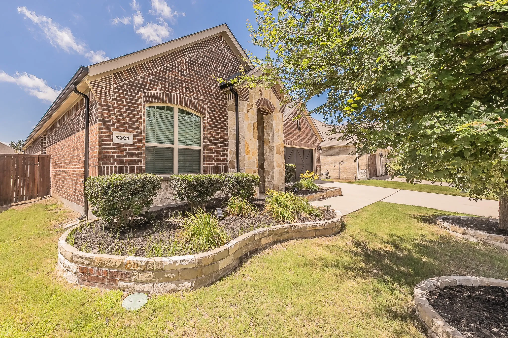 Brick and stone facade featuring an arched entry