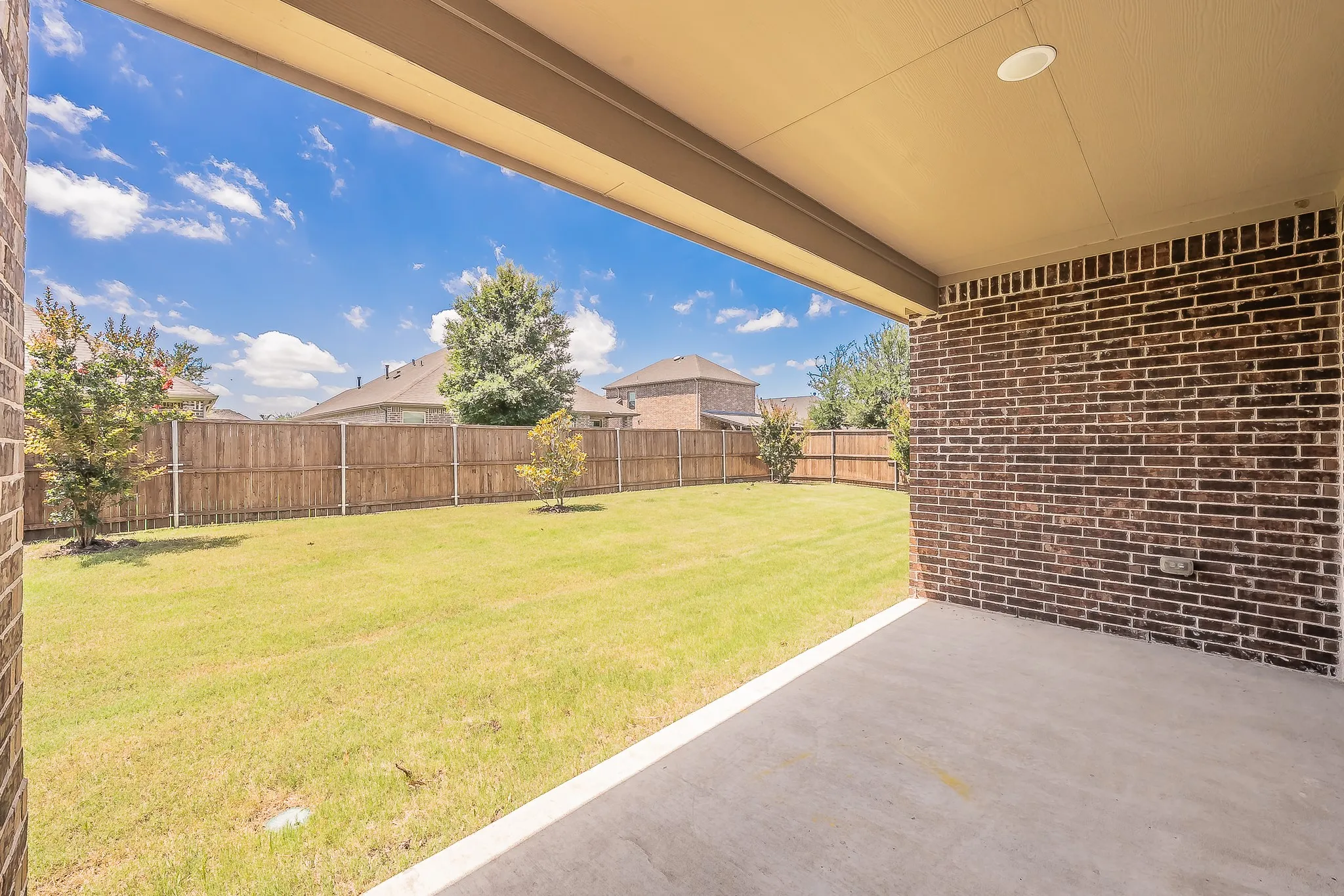 Covered concrete patio with a recessed ceiling light
