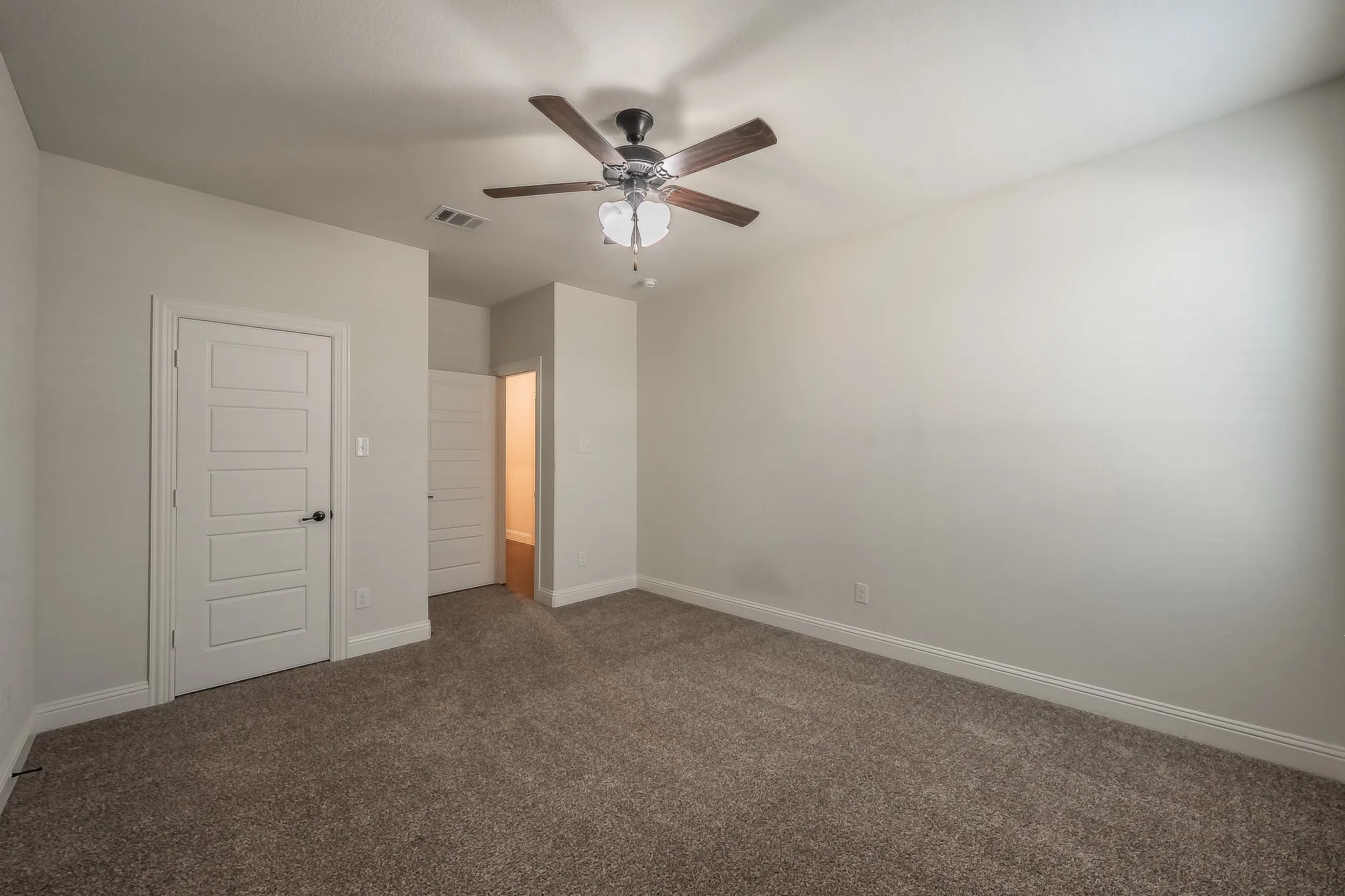 Neutral-toned carpeting and light wall paint define this interior space