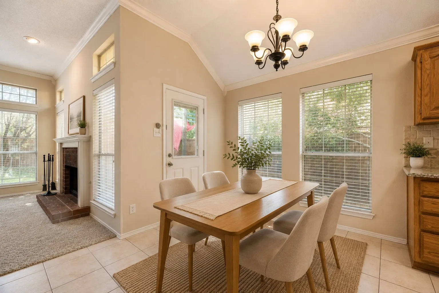 Dining area featuring a vaulted ceiling and tile flooring