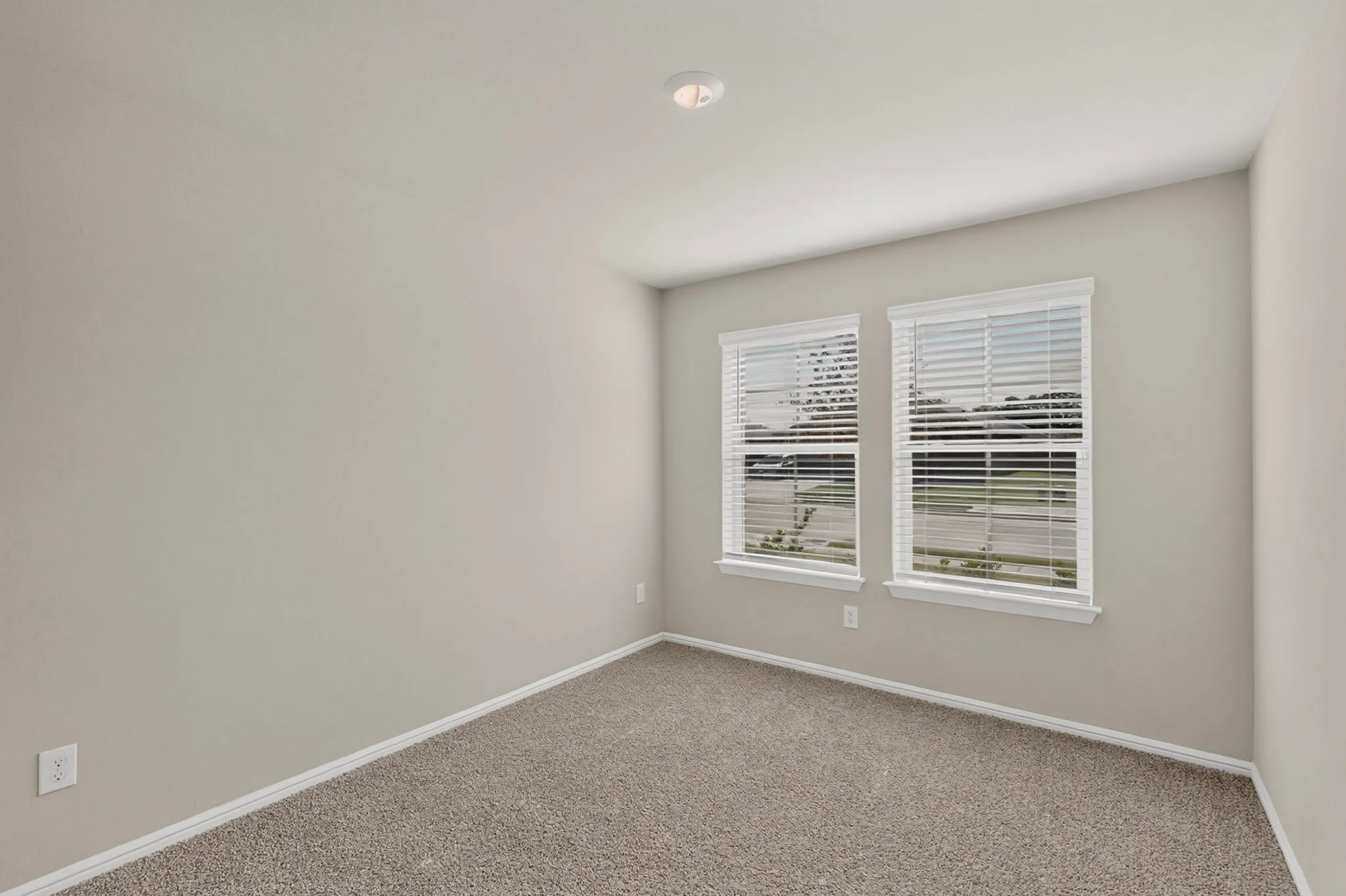 Neutral-toned walls complement plush carpet flooring