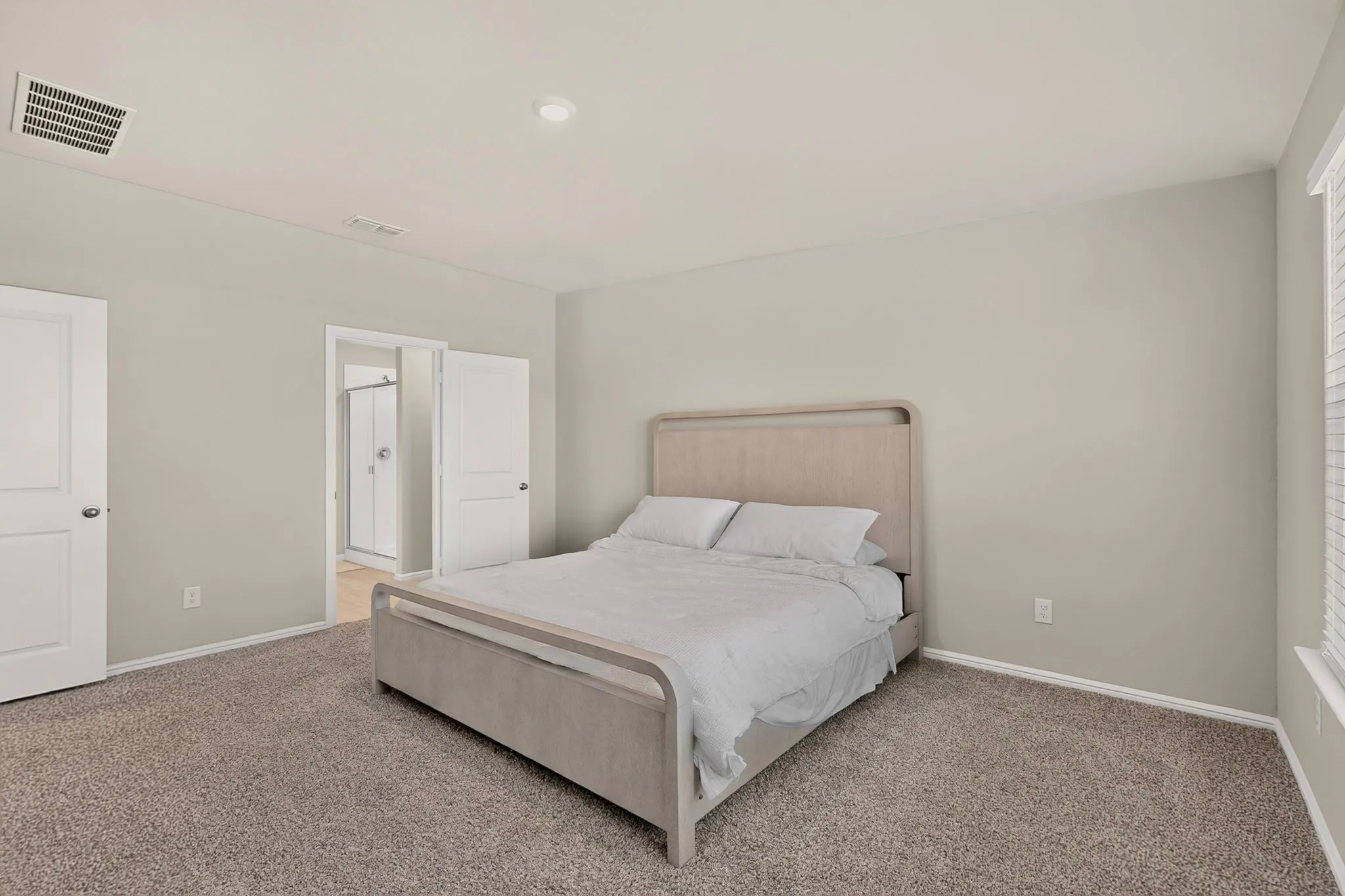 Carpeted room with light neutral wall paint and white trim