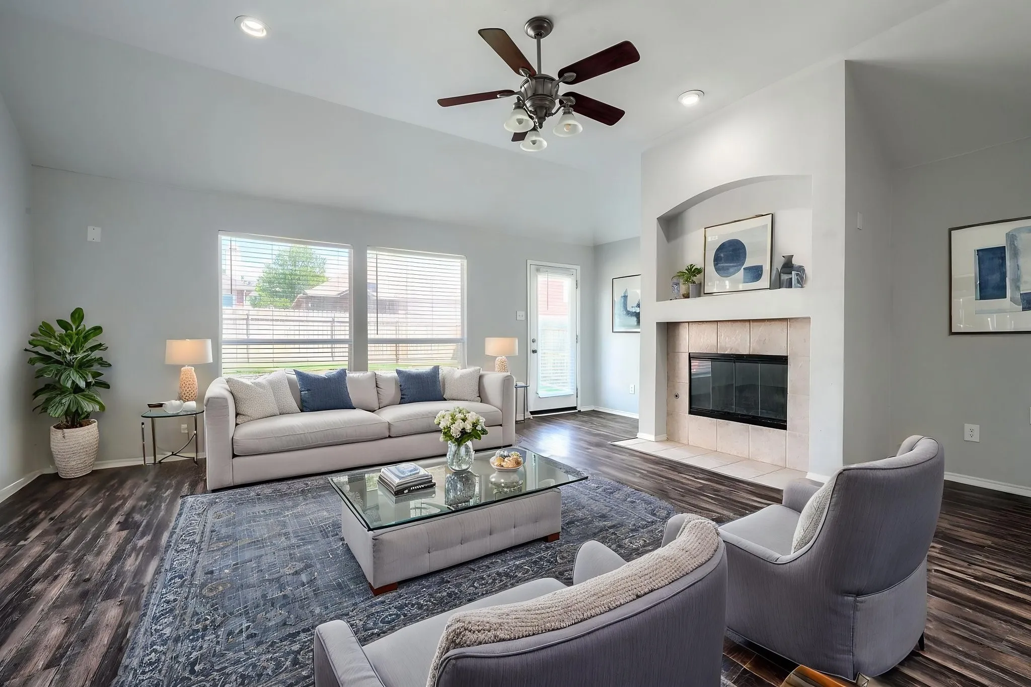 Spacious living area featuring high vaulted ceilings, recessed lighting, and dark wood-finish flooring