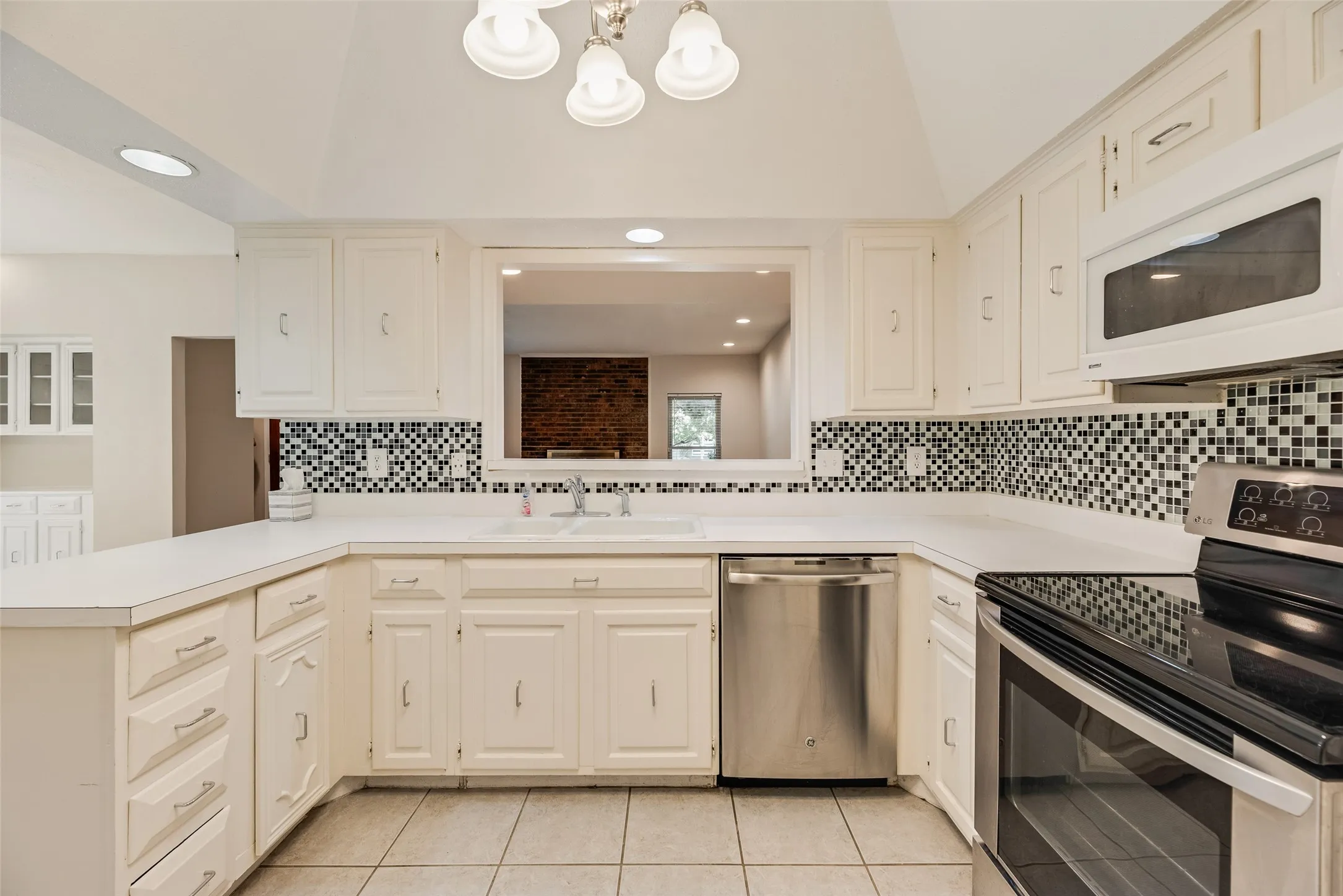 Bright kitchen with white cabinetry and countertops