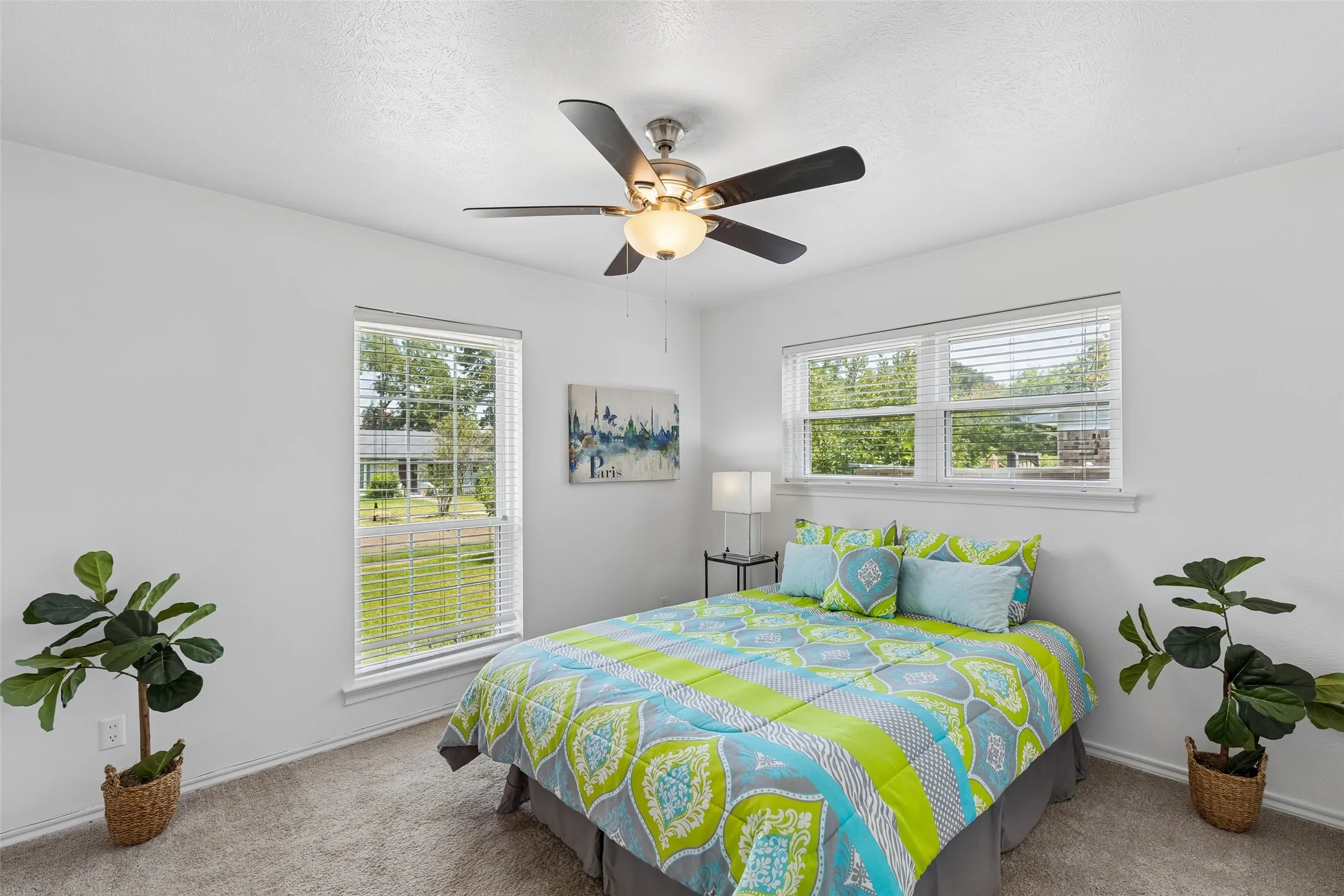 Bedroom 1 has access to full bath with dual sinks and views to the front yard.