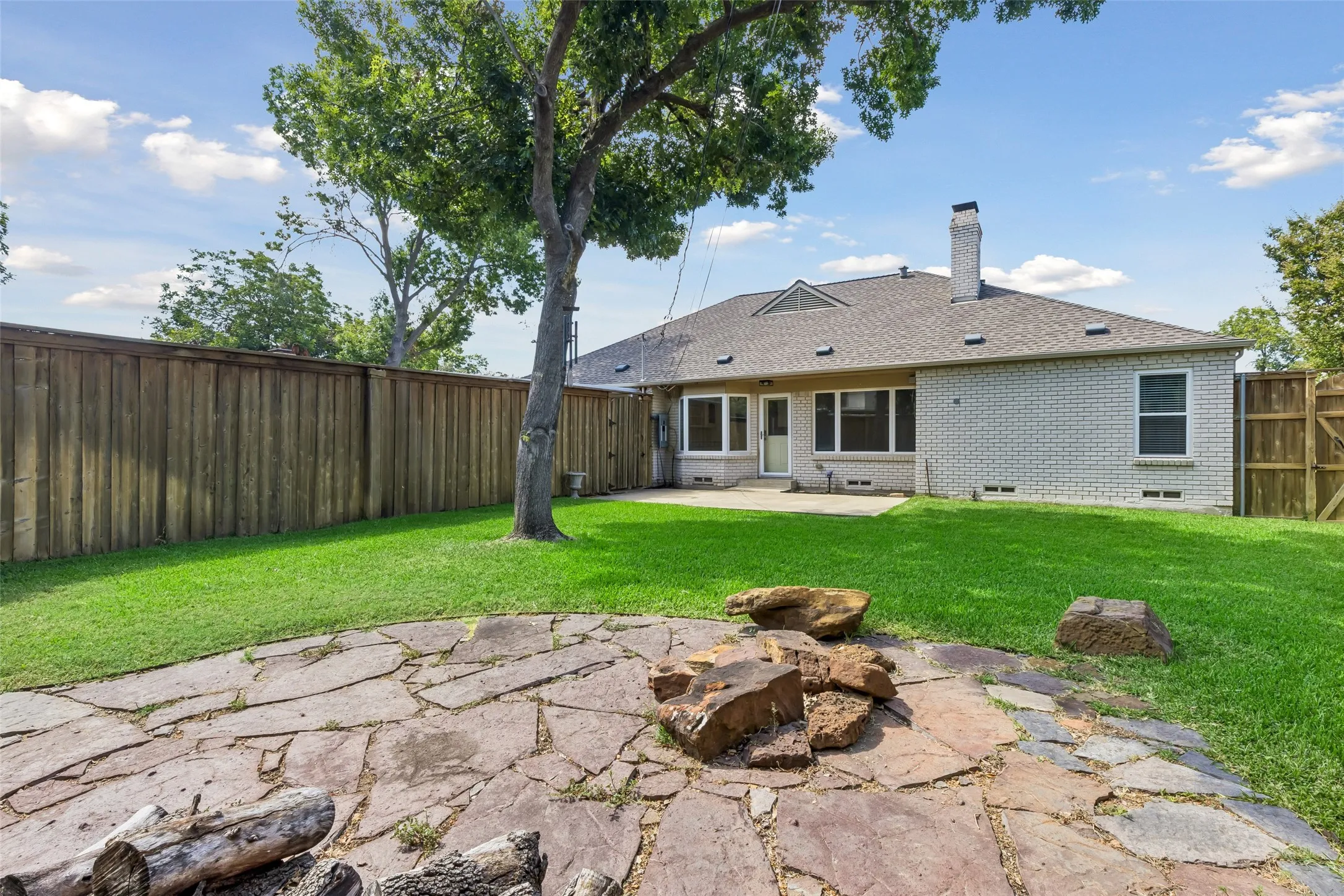 A stone patio offers dual entertaining spaces and a place for a firepit. Invite your fiends to relax under the stars at your home on Twilight Trail.