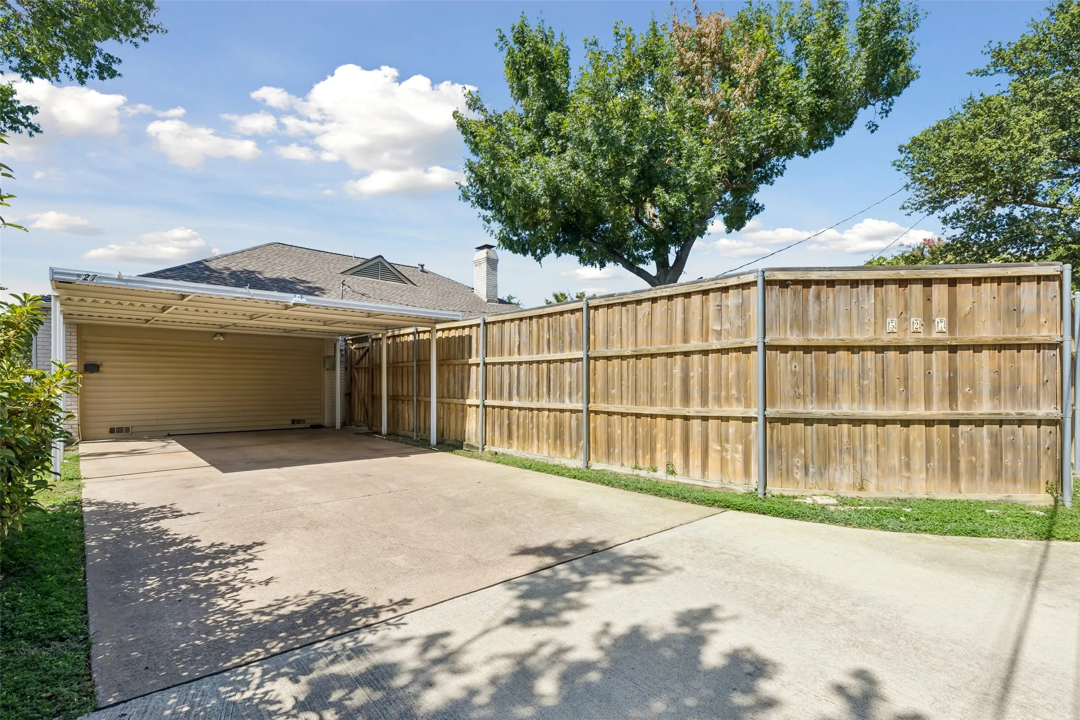 Extra long driveway with 2 car covered parking offers space for 4 cars to park in driveway
