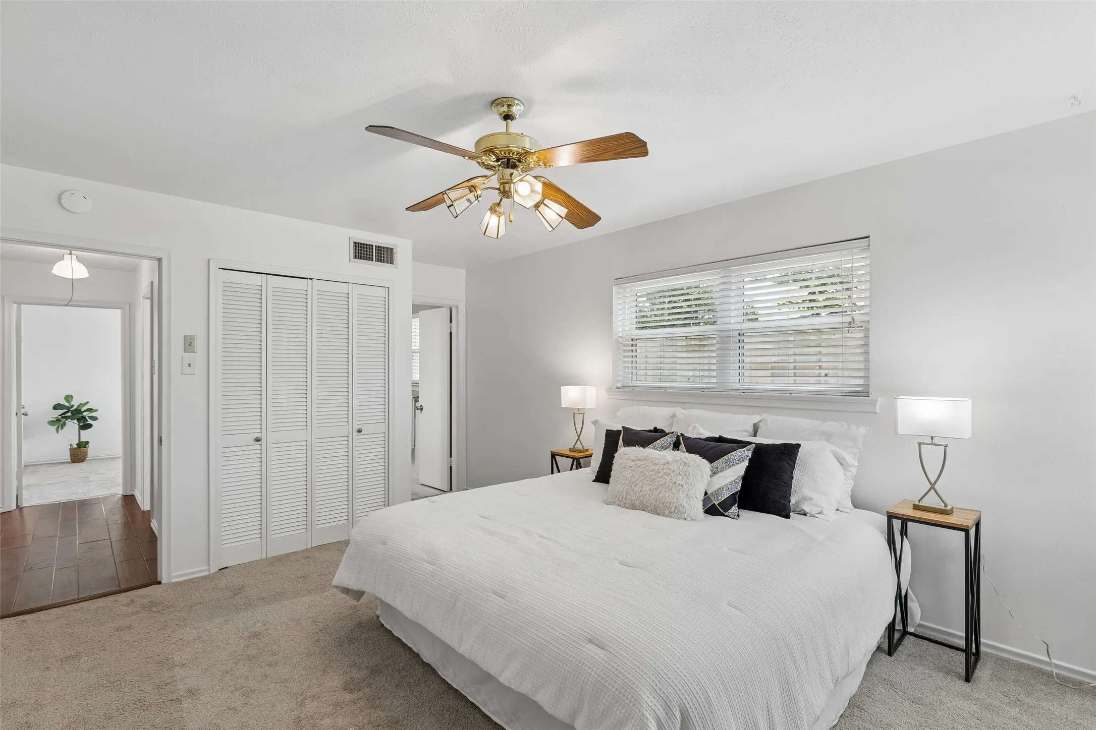 Bedroom 2 has access to full bath with dual sinks. Windows look out to backyard.