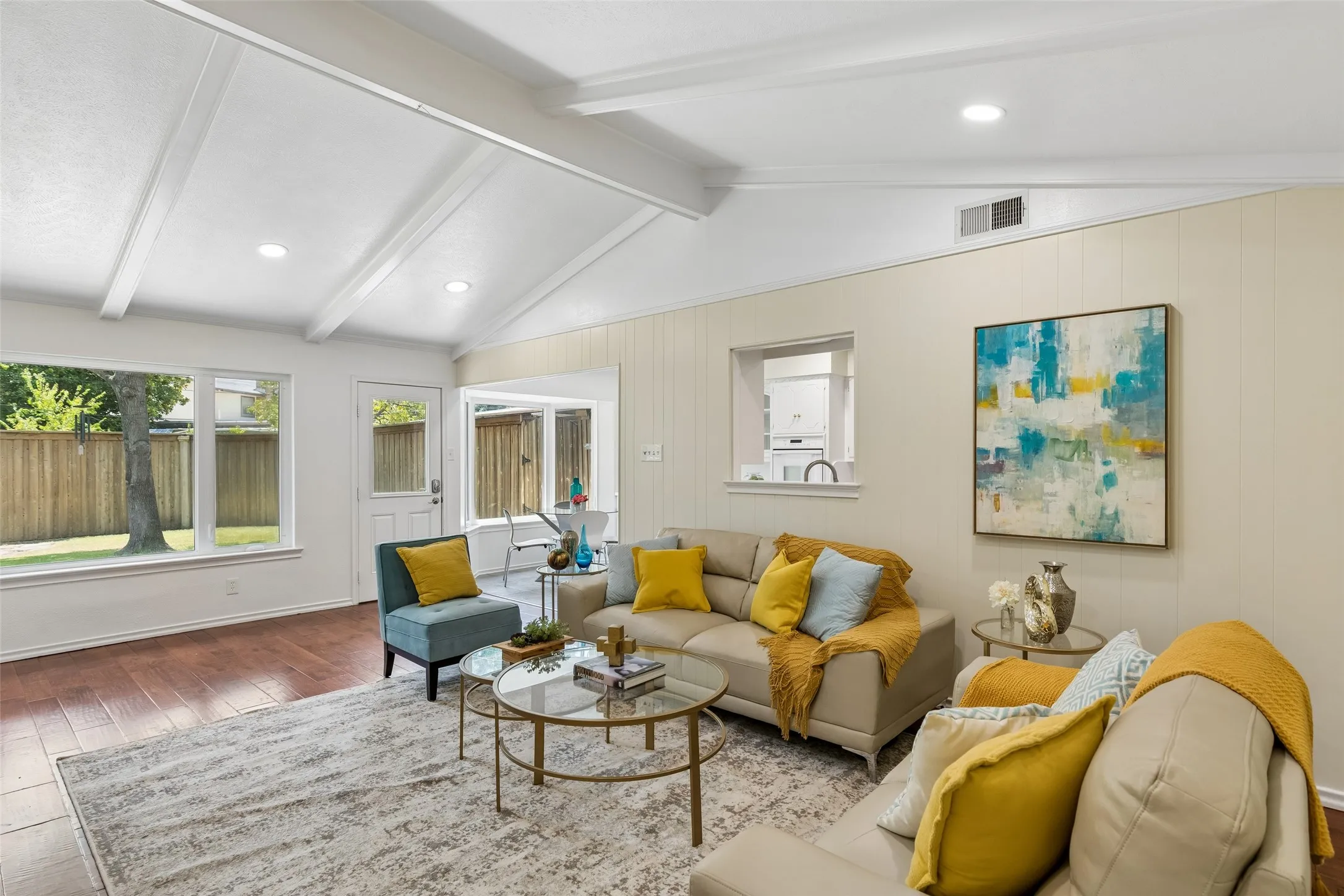 Bright & cheerful family room offers a vaulted ceiling with updated LED lighting, large brick fireplace, open to the kitchen and views to the backyard.