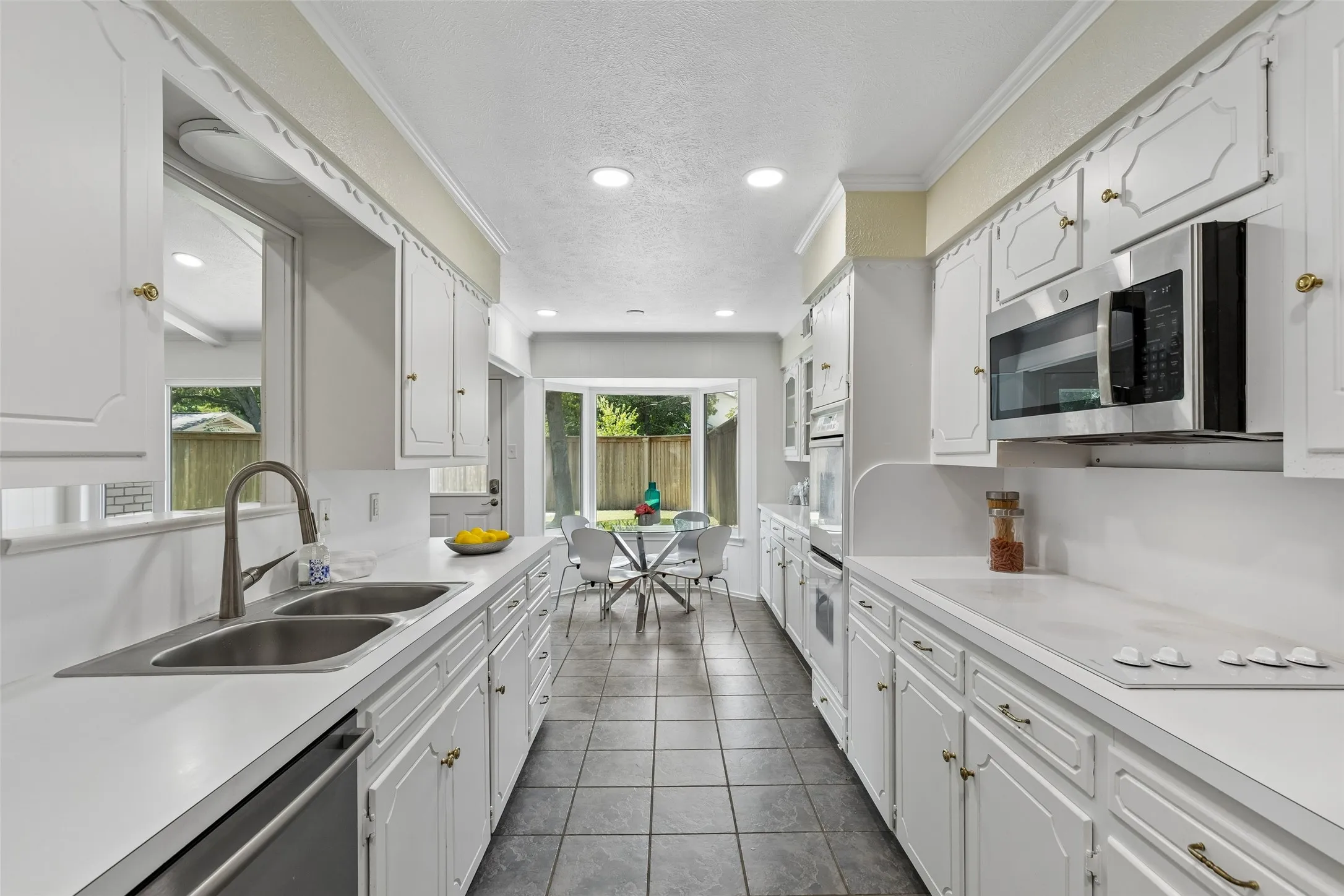 Kitchen is flooded with natural light and opens to the family room and front living / dining area. Enjoy sweeping views of the back yard too!