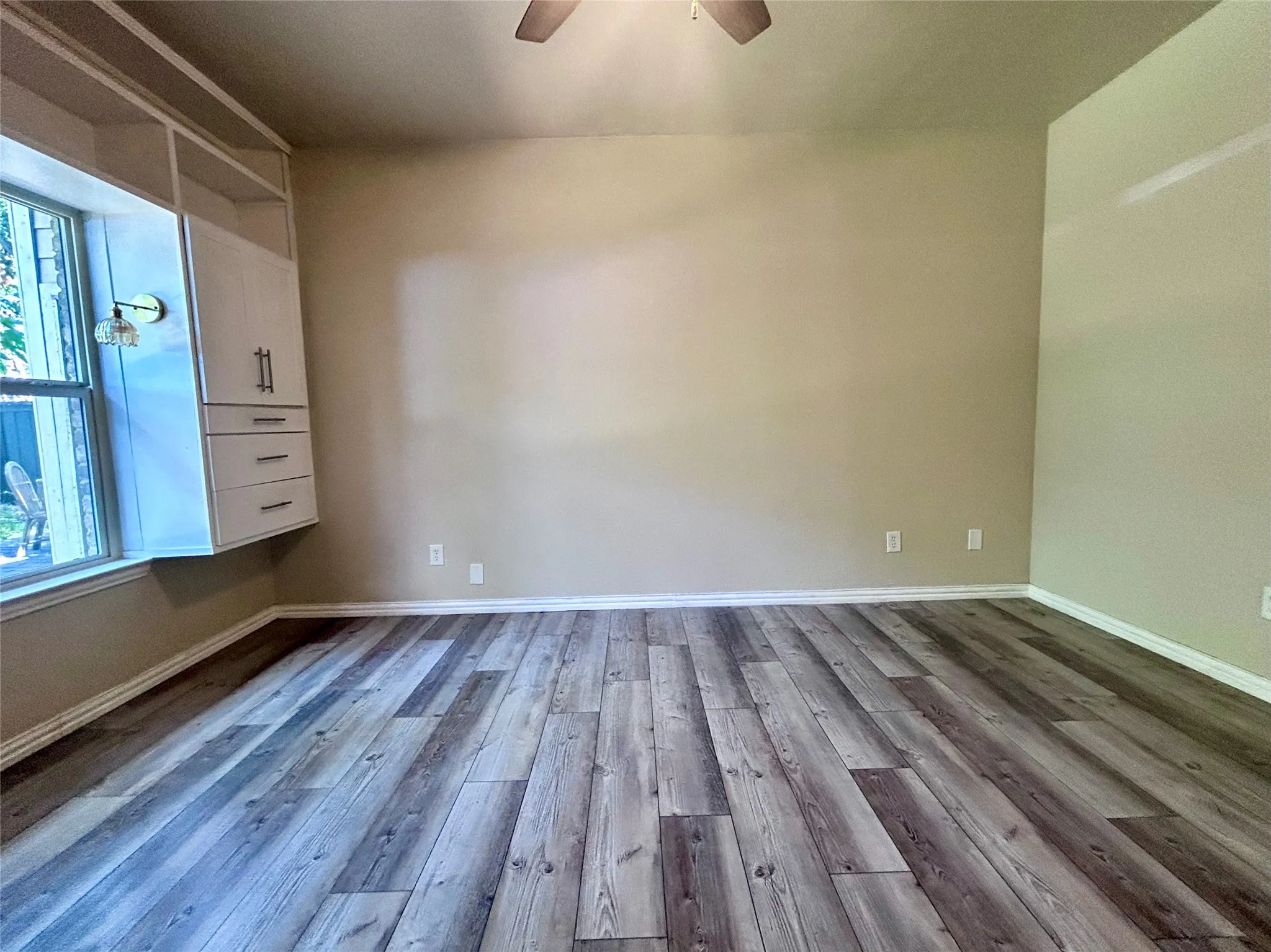 The bedroom features a ceiling fan, walk in closet, private access to the bath and built in storage!