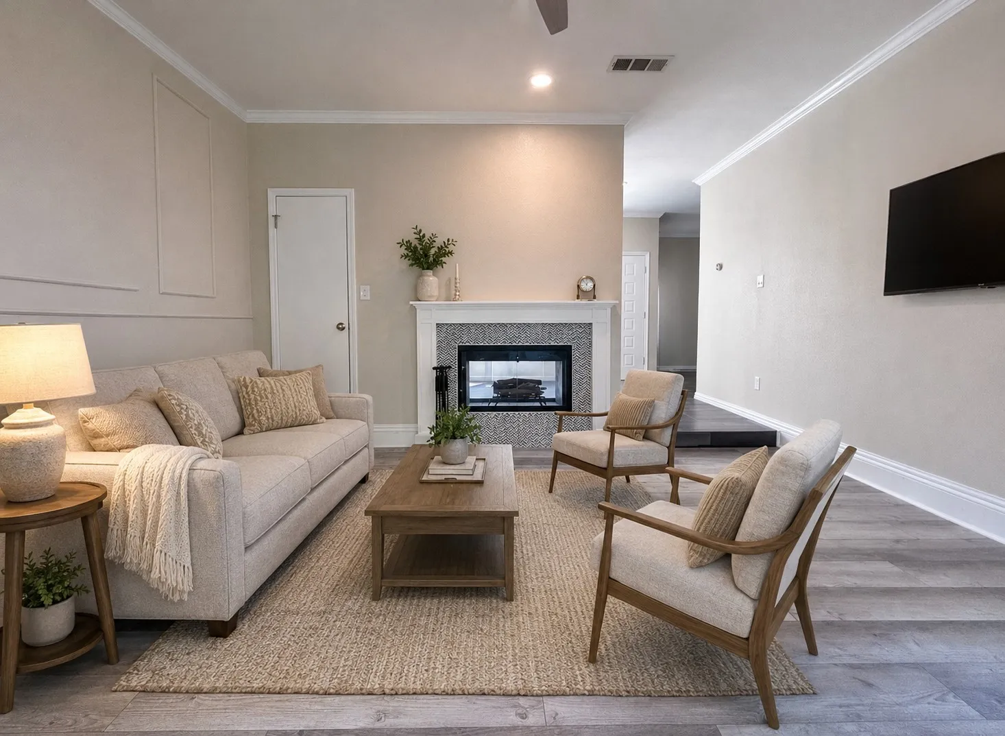 VIRTUALLY STAGED -Living area featuring a fireplace with a stone tile surround, a white mantel, and crown molding