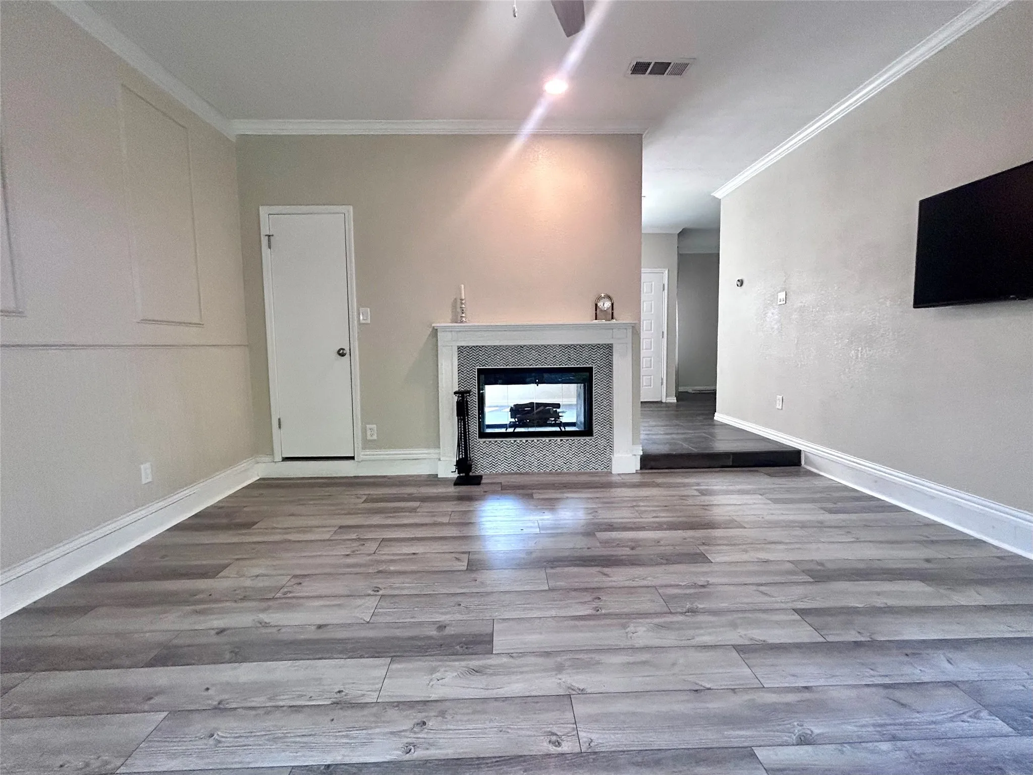 The family room features updated flooring and a double sided fireplace.