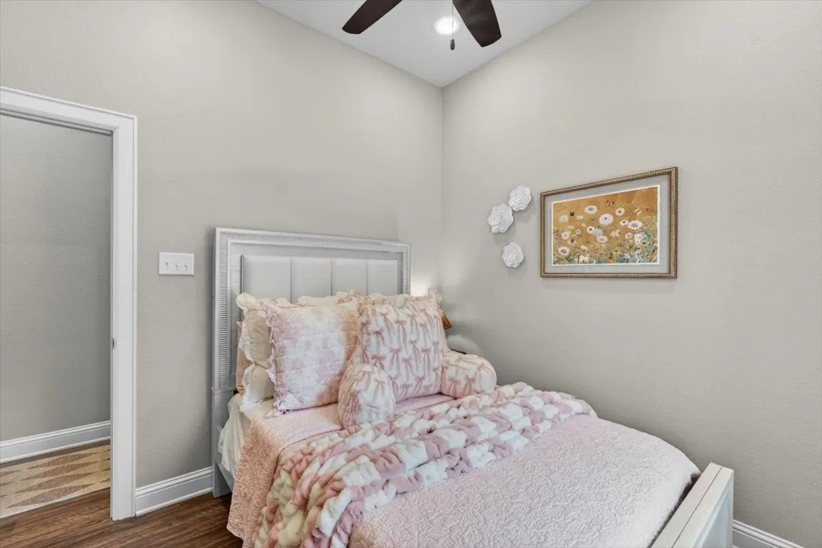 Room featuring a vaulted ceiling and wood-finish flooring
