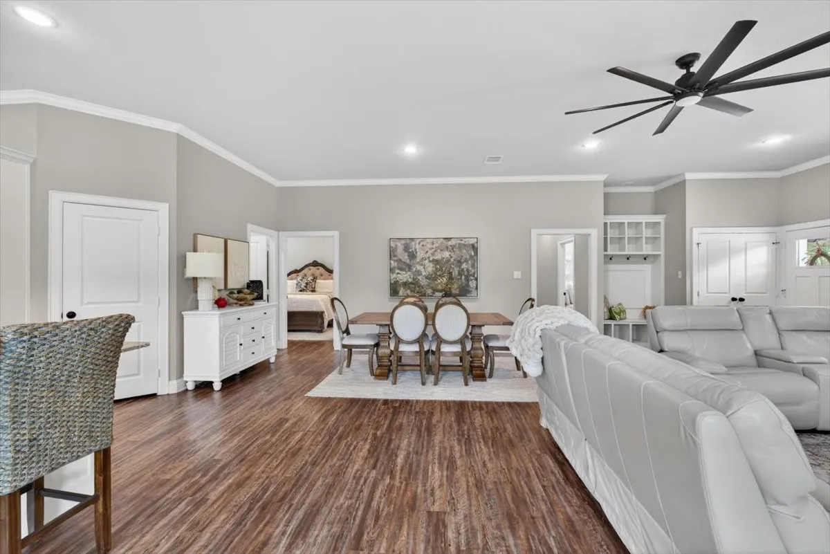 Spacious interior featuring wood-finish flooring, recessed lighting, and crown molding