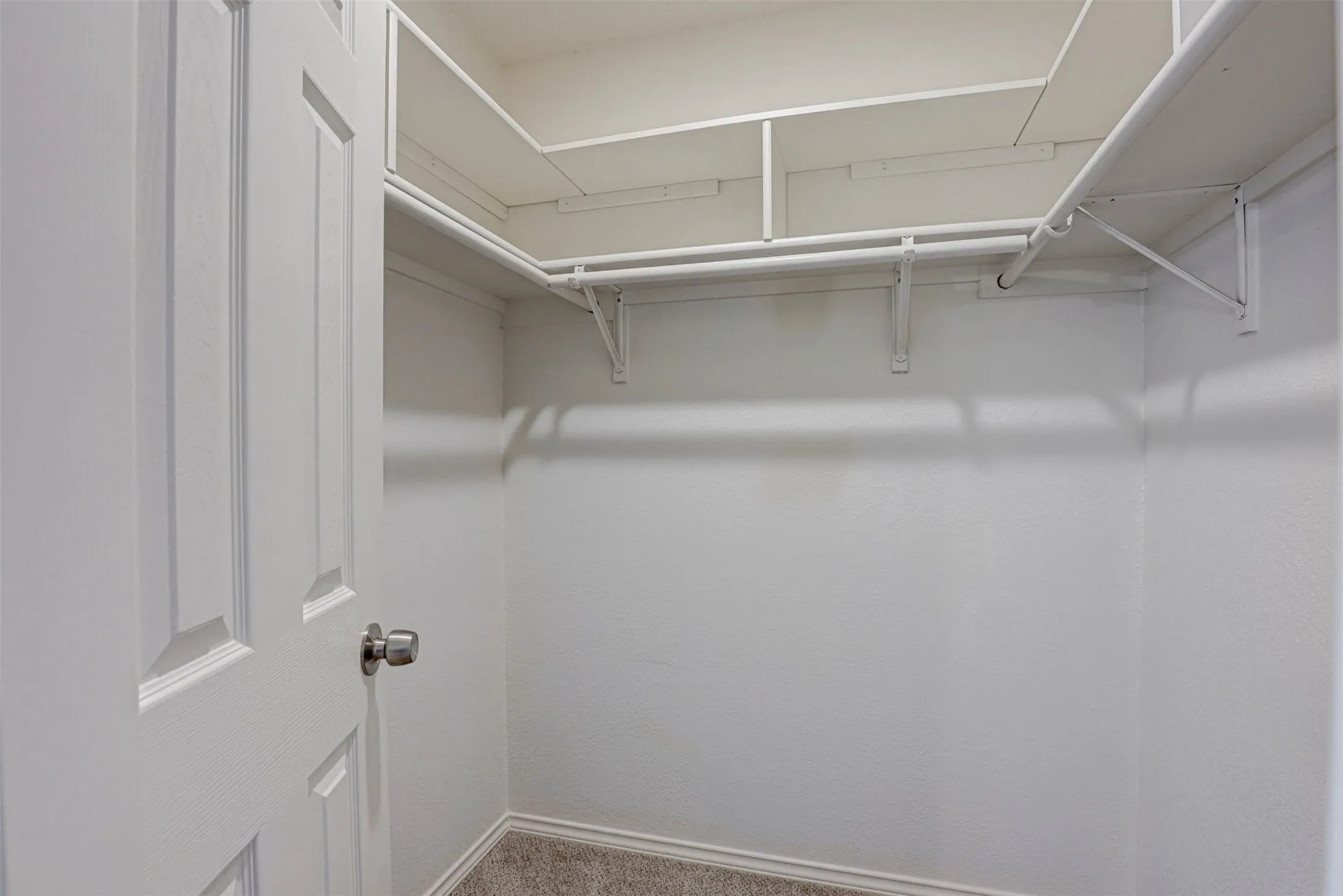 Spacious walk-in closet in the primary bedroom