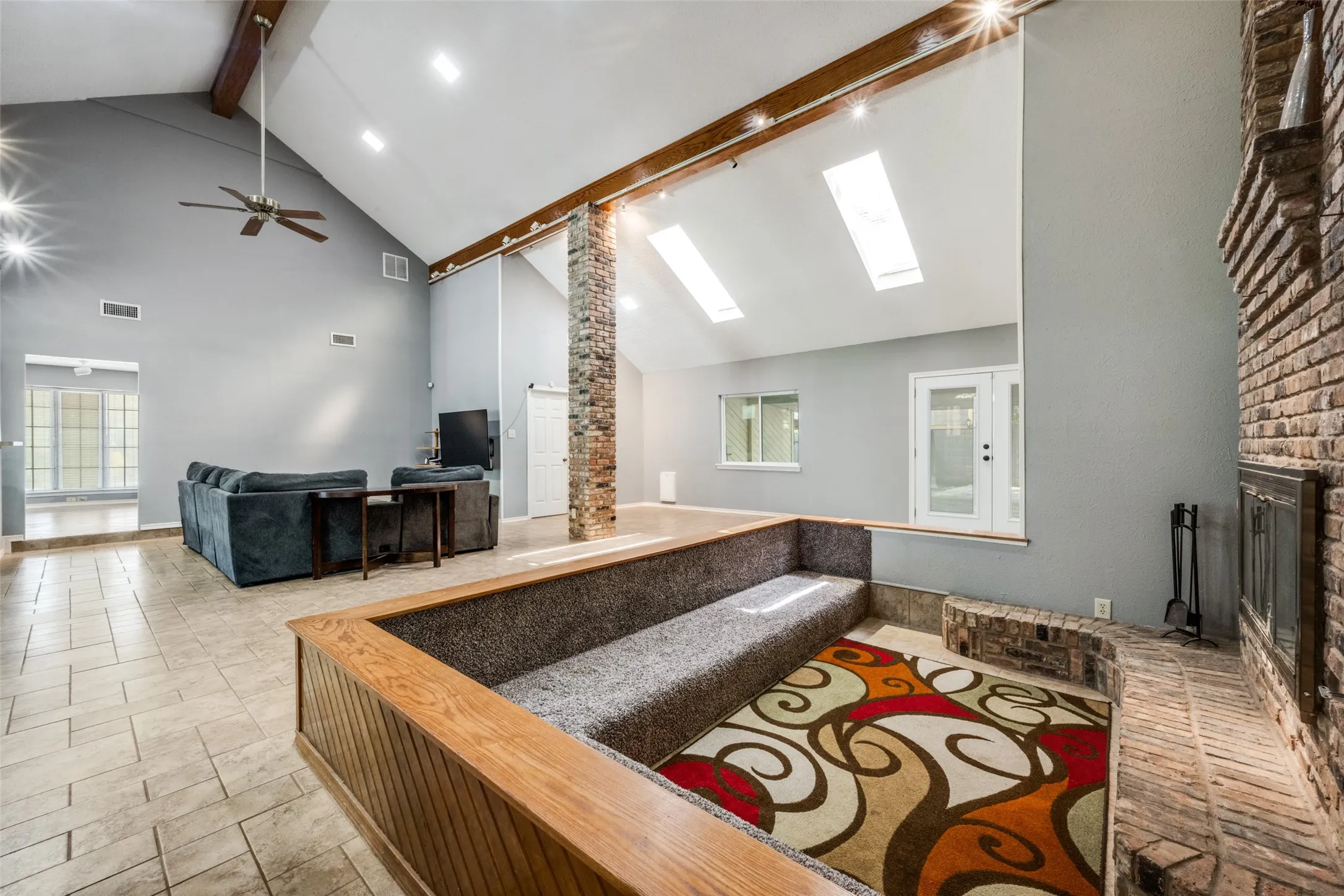 Vaulted ceiling featuring exposed beams, recessed lighting, and a ceiling fan