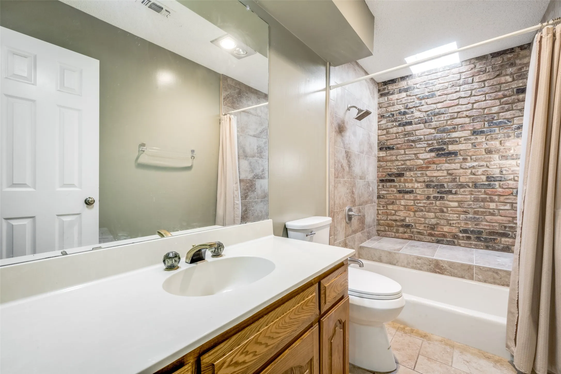 Bathroom featuring a vanity with a white countertop and wood-finish cabinetry
