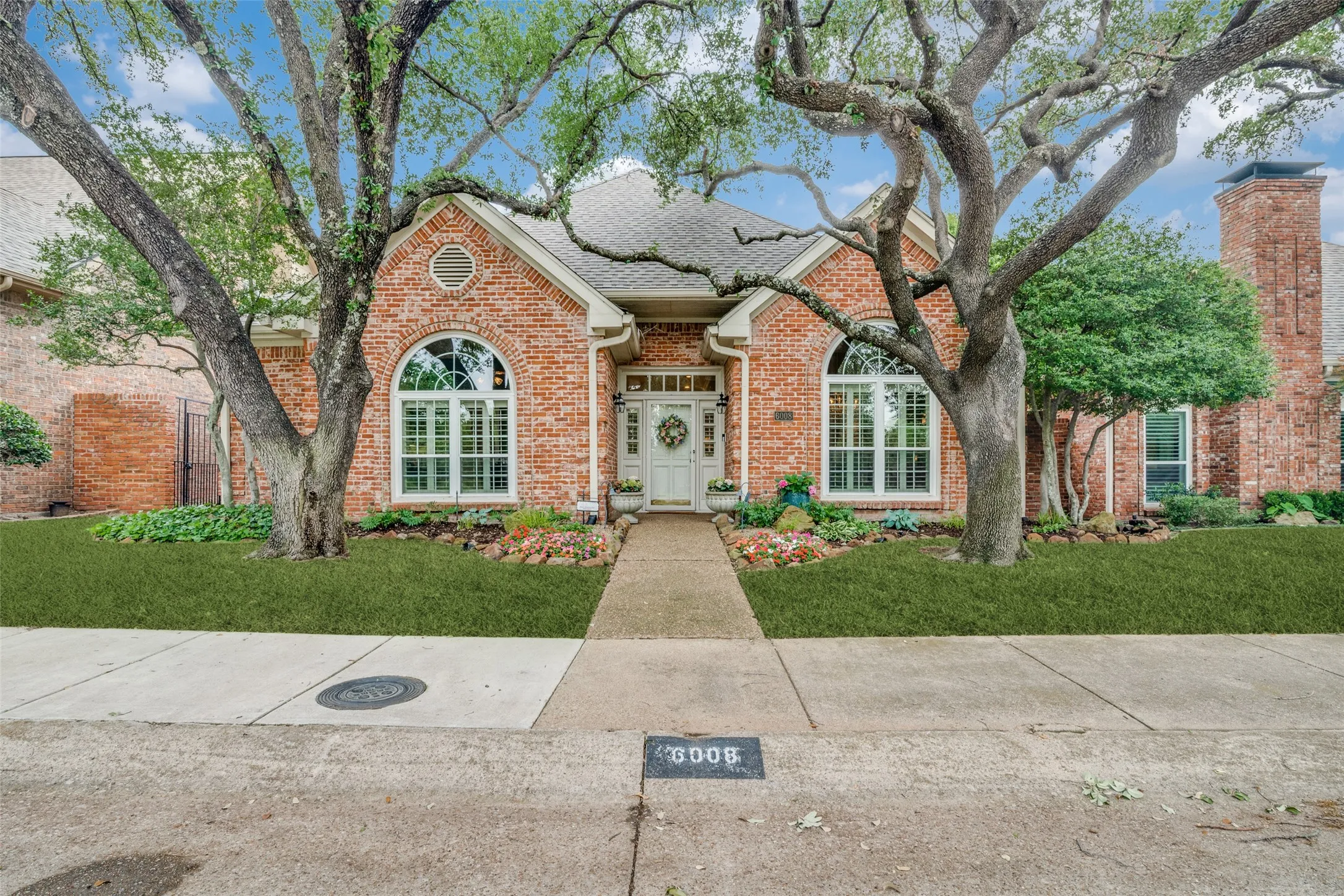 Brick exterior featuring a gabled roofline and arched windows