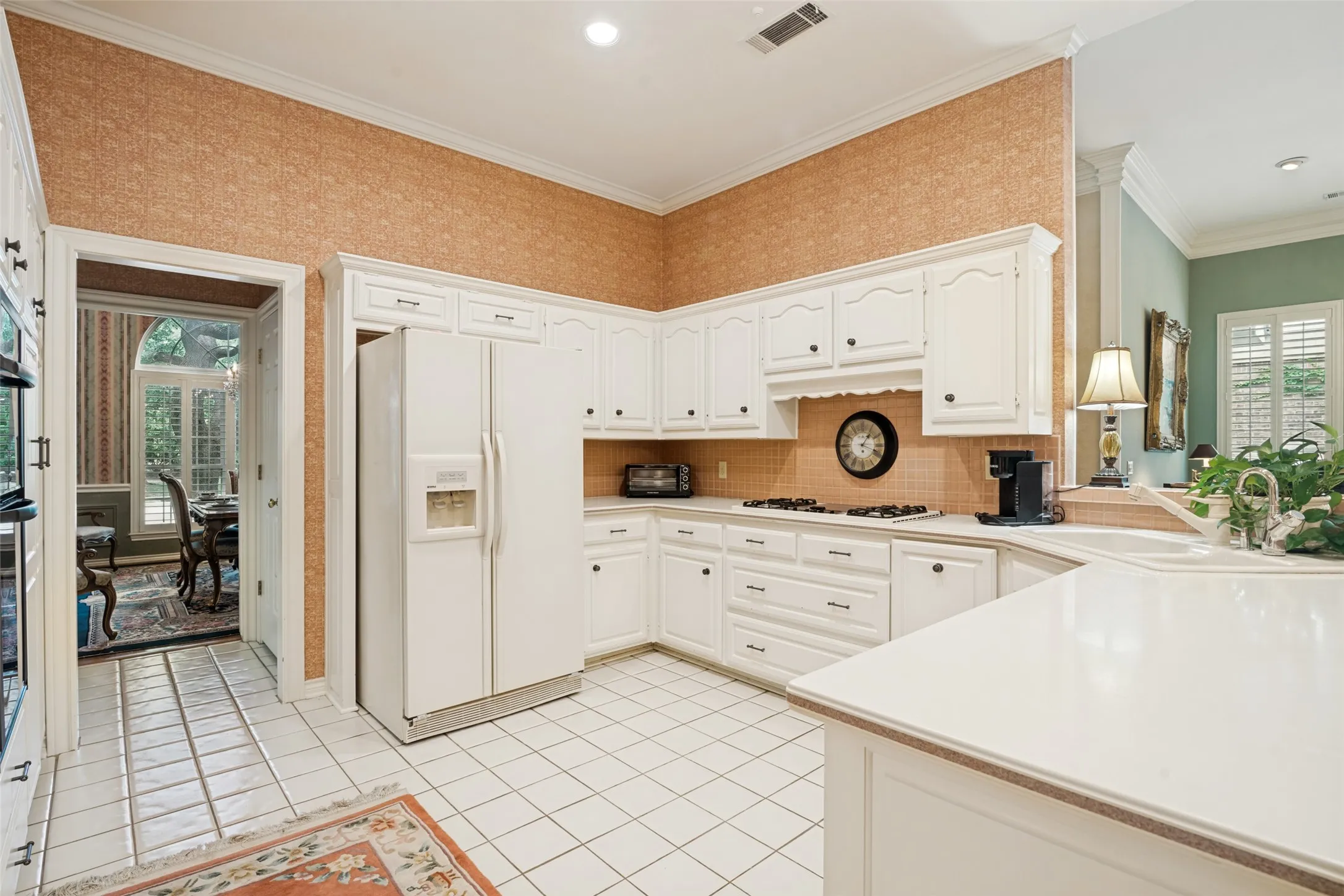Kitchen featuring white cabinetry, tile flooring, and light-toned countertops