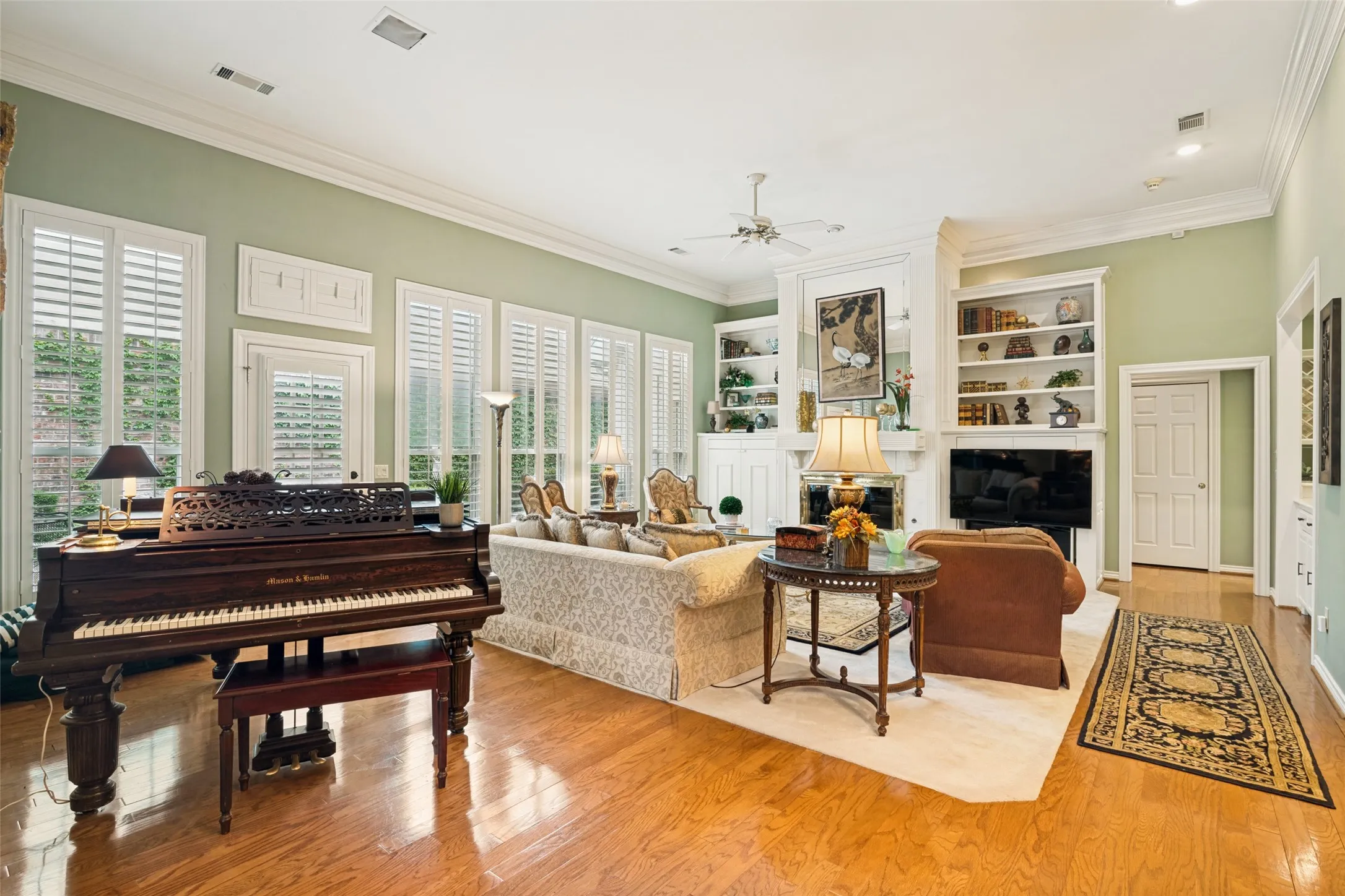 Spacious living area featuring polished wood-finish flooring