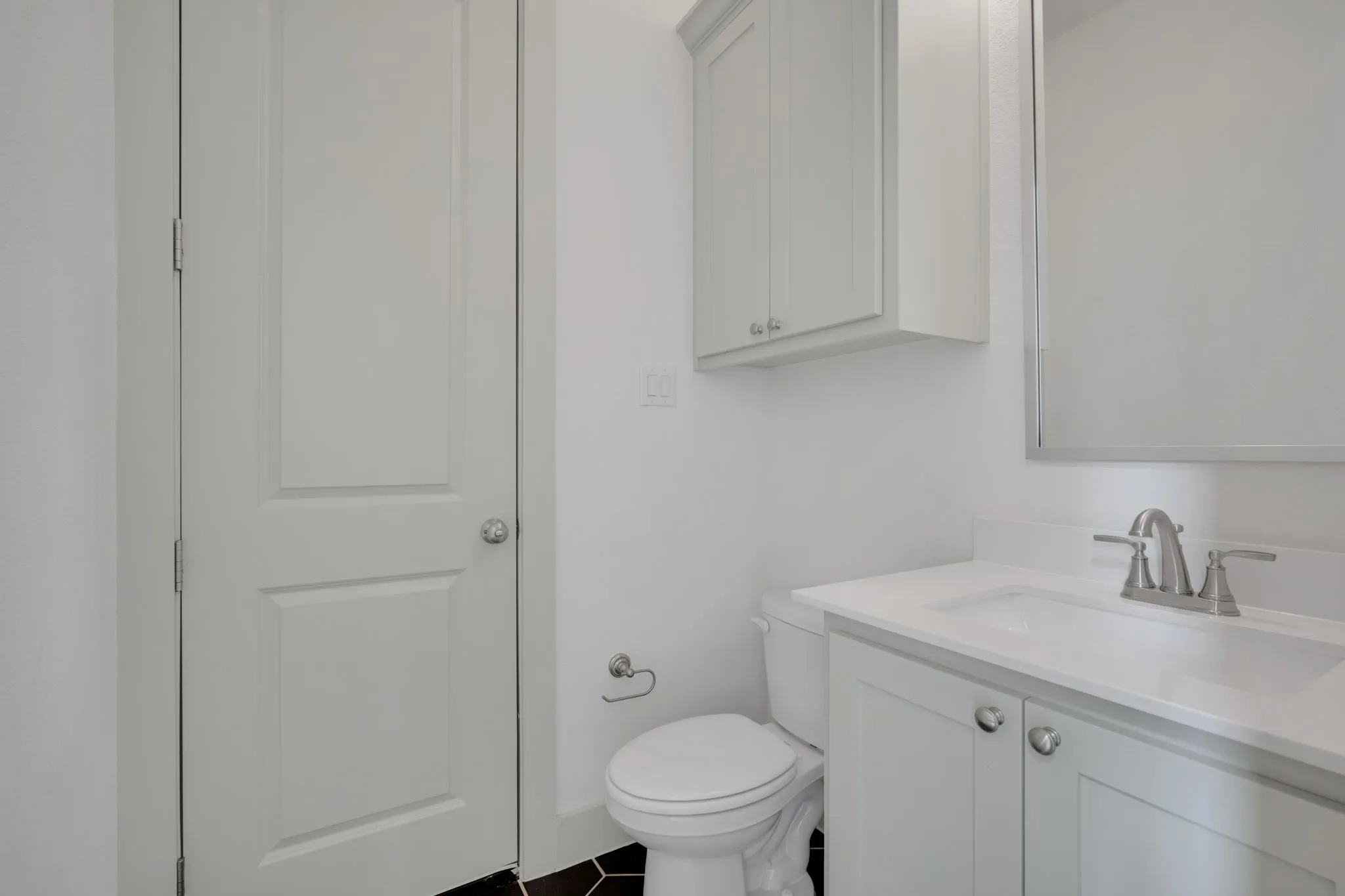 Half bath behind kitchen and laundry
