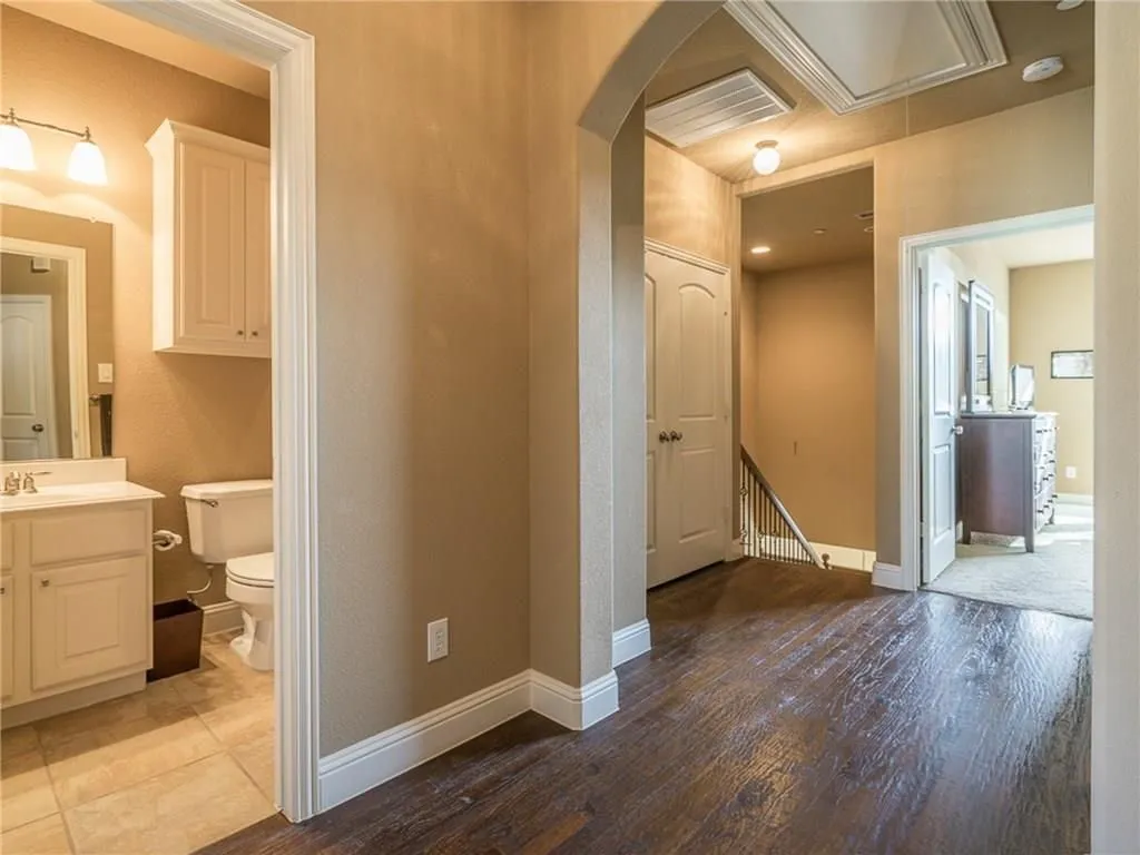 Hallway with dark wood-finish flooring and a light neutral wall color