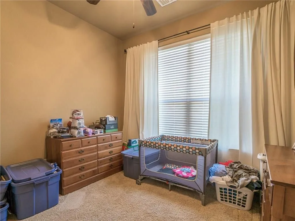 Neutral-toned walls complement plush carpeting