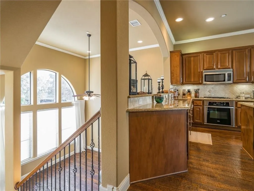 Kitchen featuring wood cabinetry, granite countertops, and stainless steel appliances