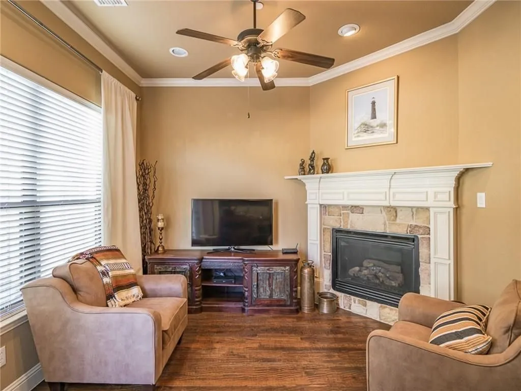 Corner fireplace with stone surround and detailed white mantel