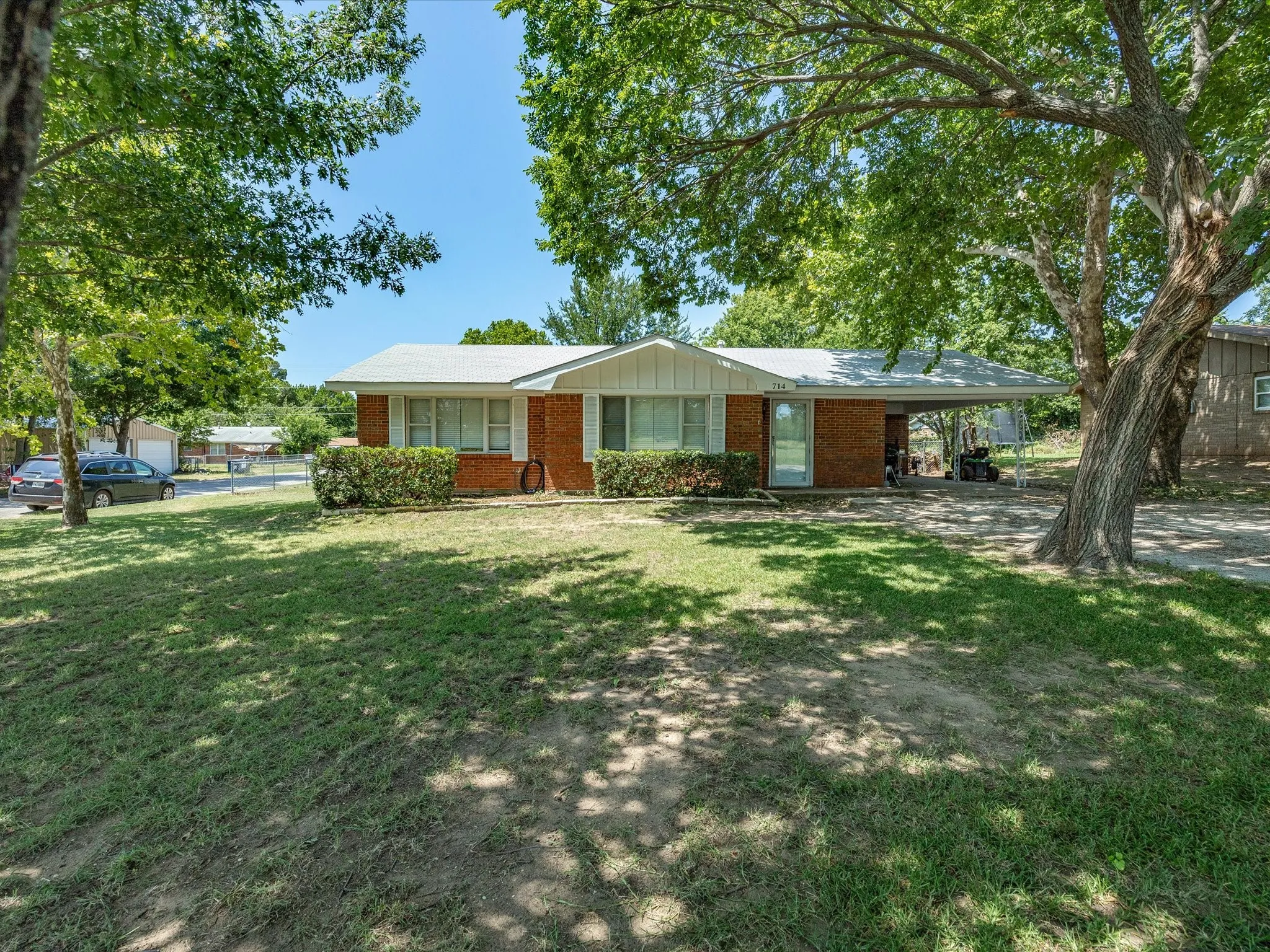 Brick Exterior Home on a large Corner Lot with a 1 Car Attached Carport and a 400 Square Foot Out Building