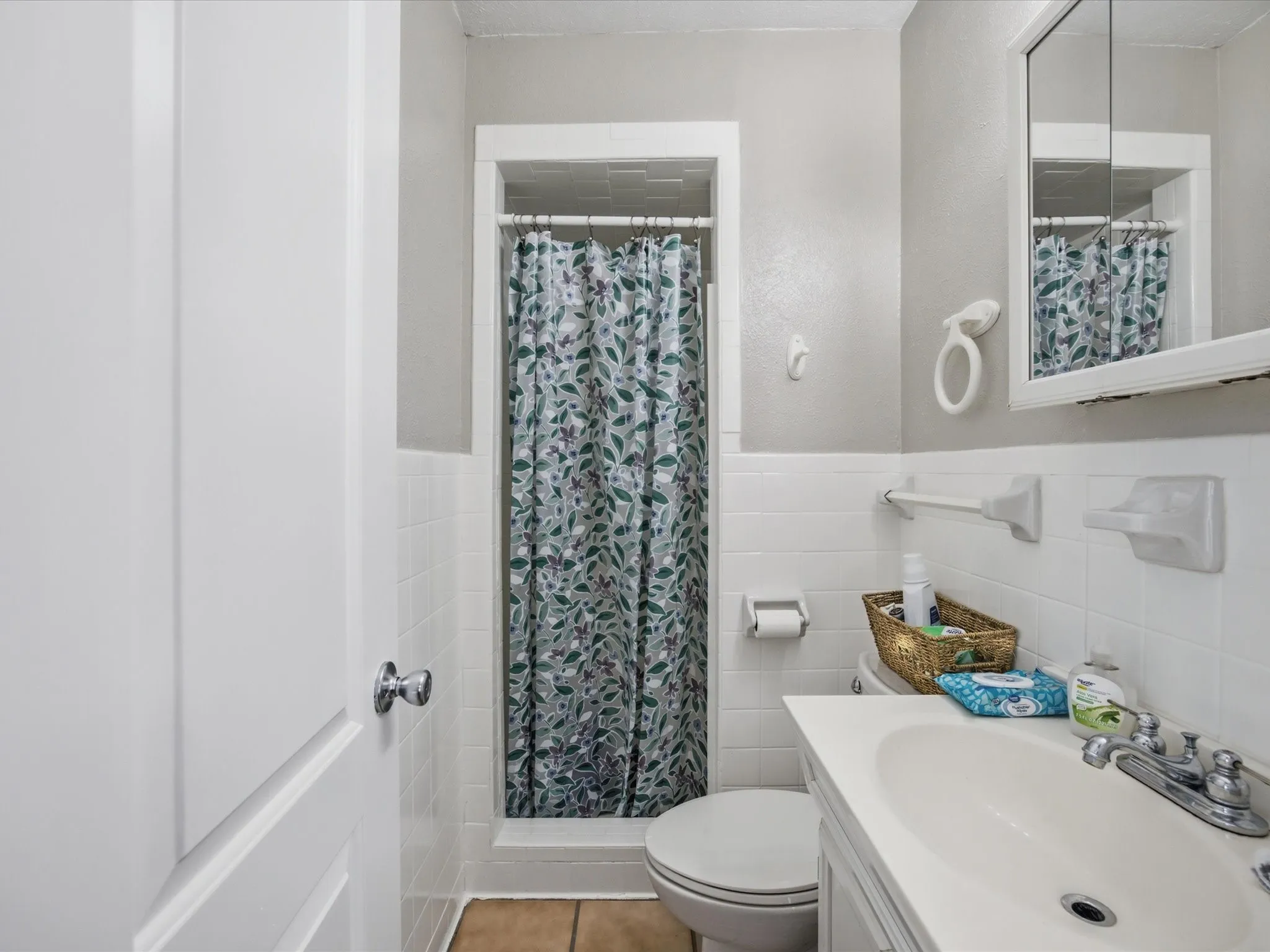 Primary Bathroom featuring a shower, tile flooring, and medicine cabinet