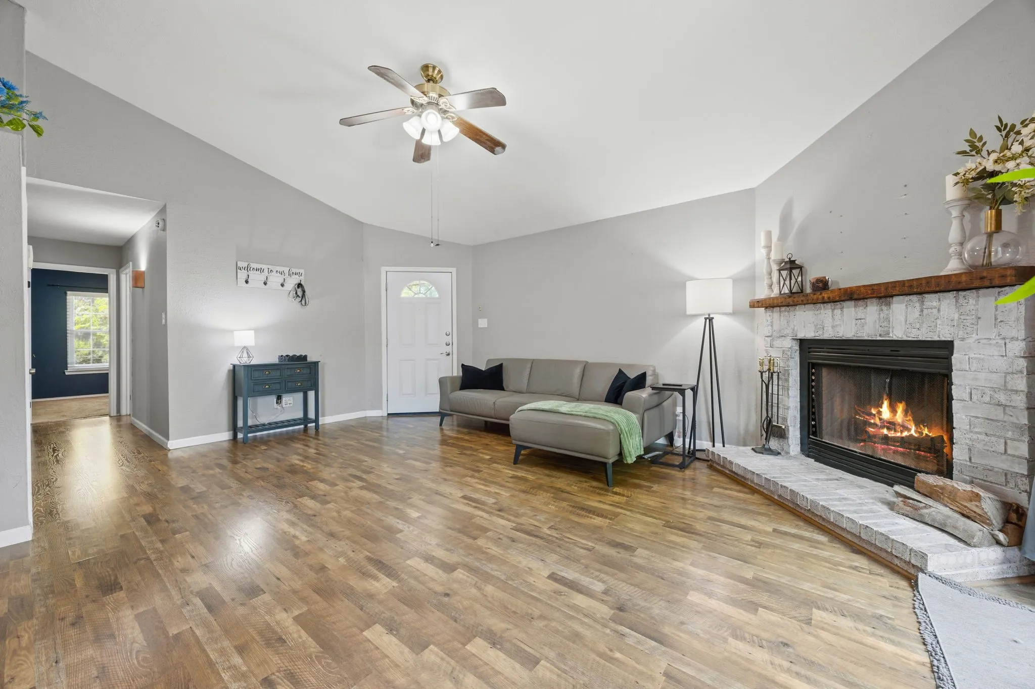 Close view of the whitewashed brick fireplace with wood
mantel, a key focal point of the living room.