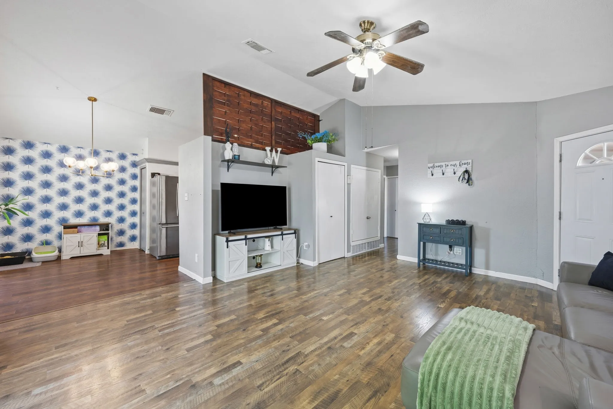 Living room with fireplace lit, sightline open through to the
kitchen and dining area.