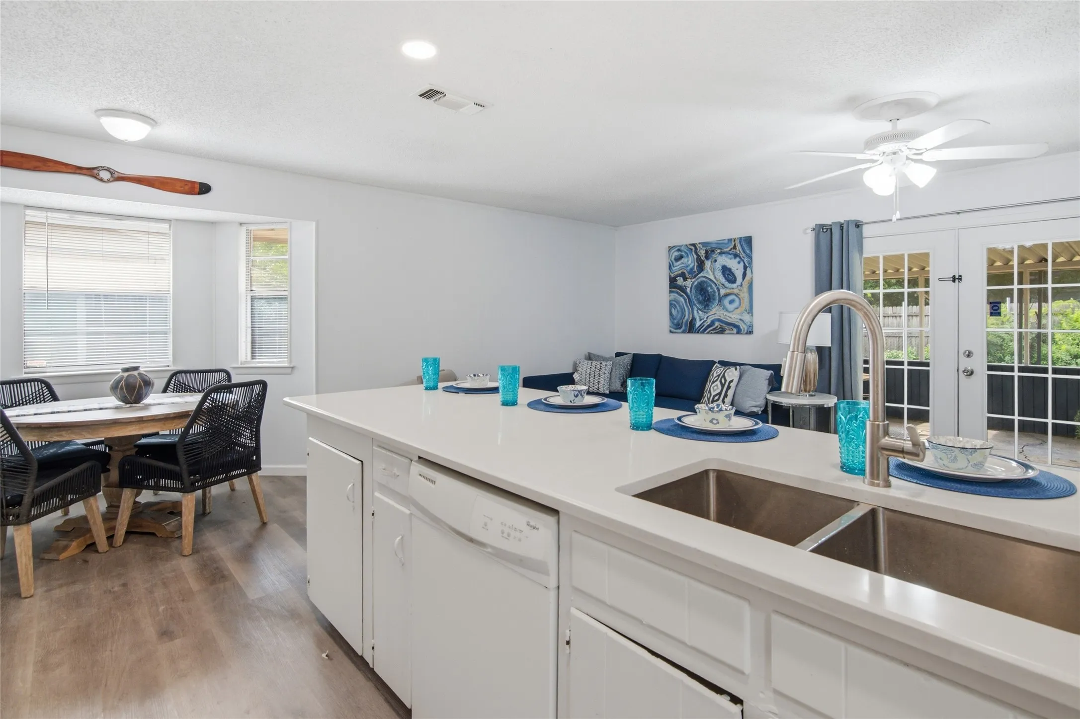 Kitchen island featuring a dual-basin stainless steel sink with a gooseneck faucet
