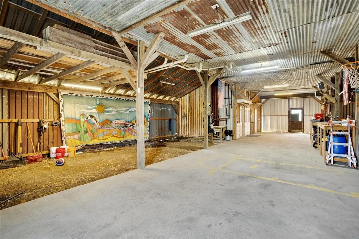 Dirt floor on either side of concrete set up to accommodate multiple 12' x 12' stalls