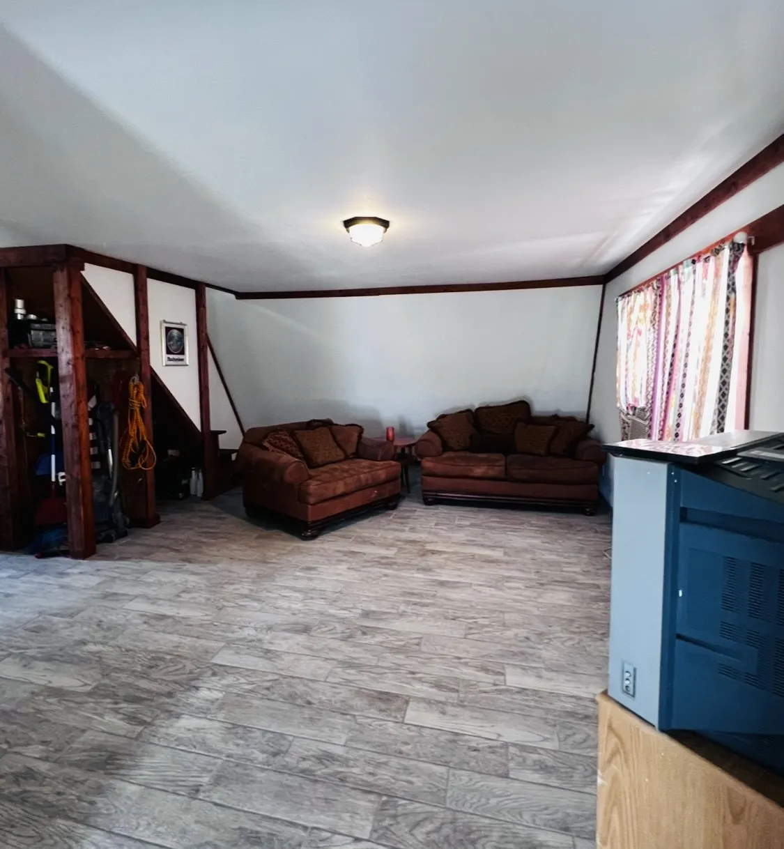 Spacious interior featuring wood-finish flooring, white walls, and dark wood trim