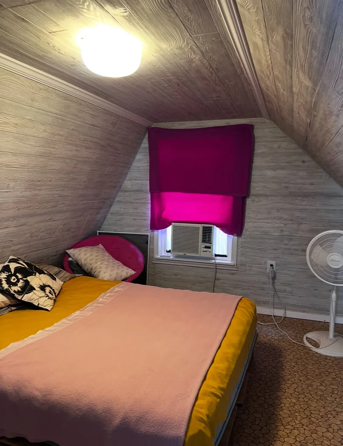 Sloping wood-finish paneled walls and ceiling