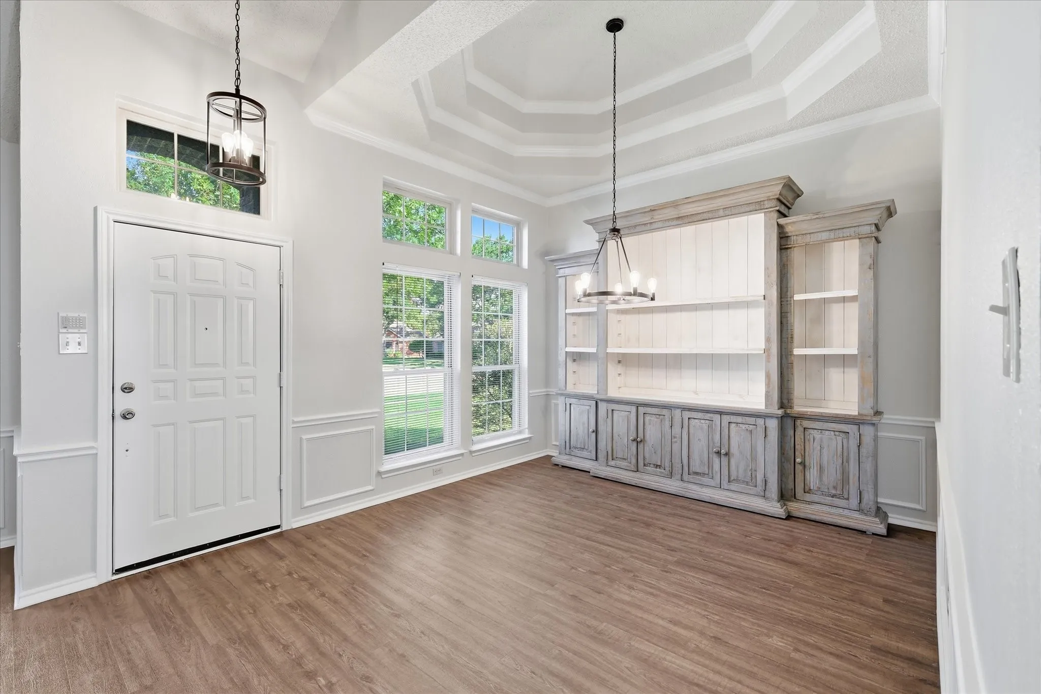 Soaring ceilings, oversized windows and a striking built-in display cabinet give this dining space impressive character and charm.