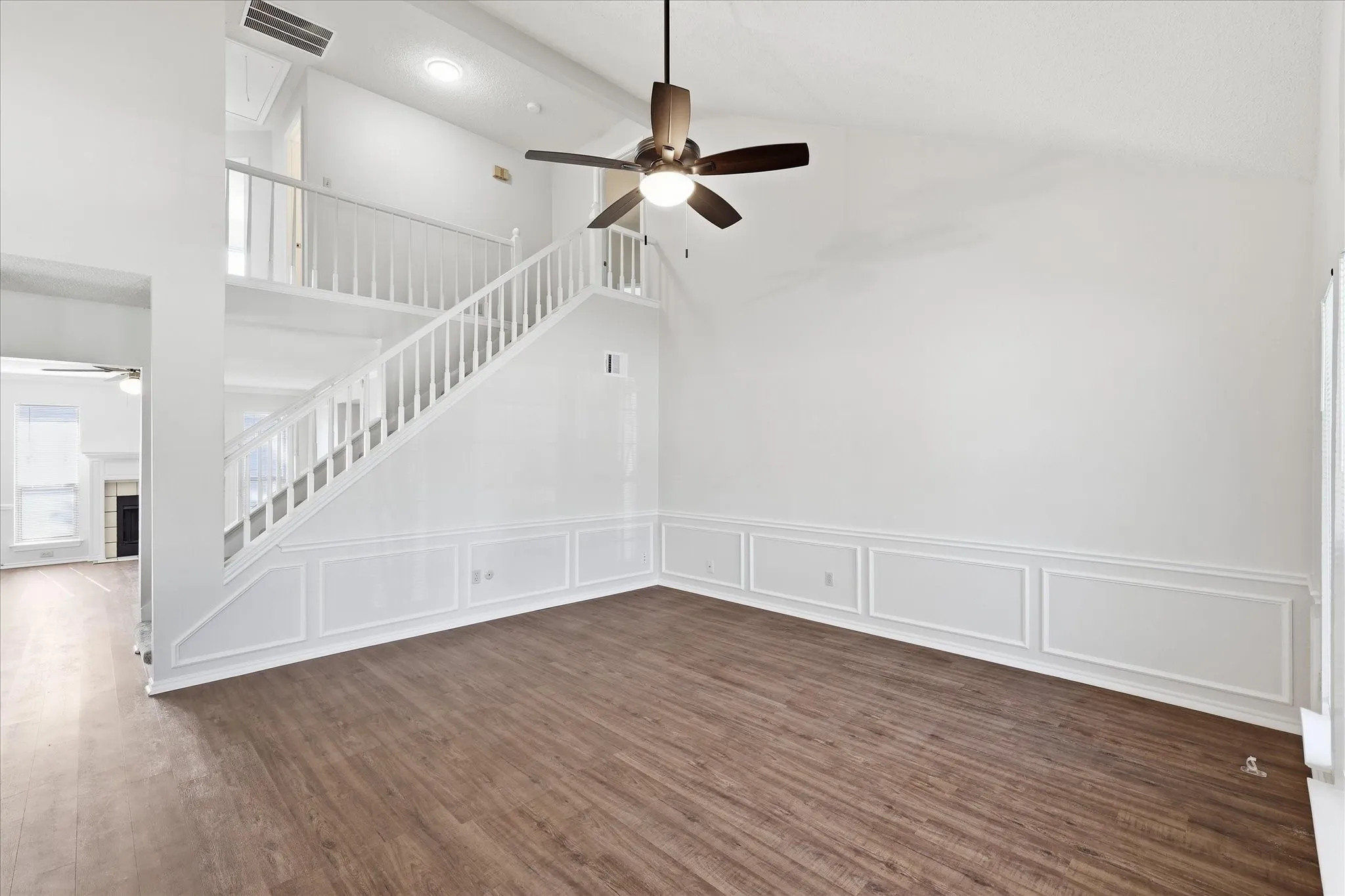 A light-filled living area with vaulted ceilings, expansive windows and plenty of room to create a comfortable everyday retreat.