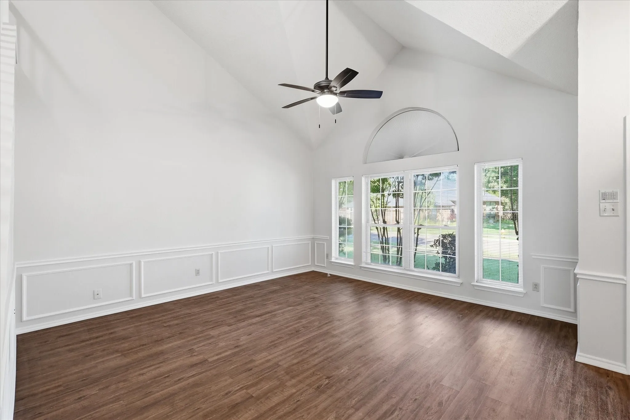 The open, airy living room showcases tall ceilings, natural light and a spacious layout designed for effortless relaxation.