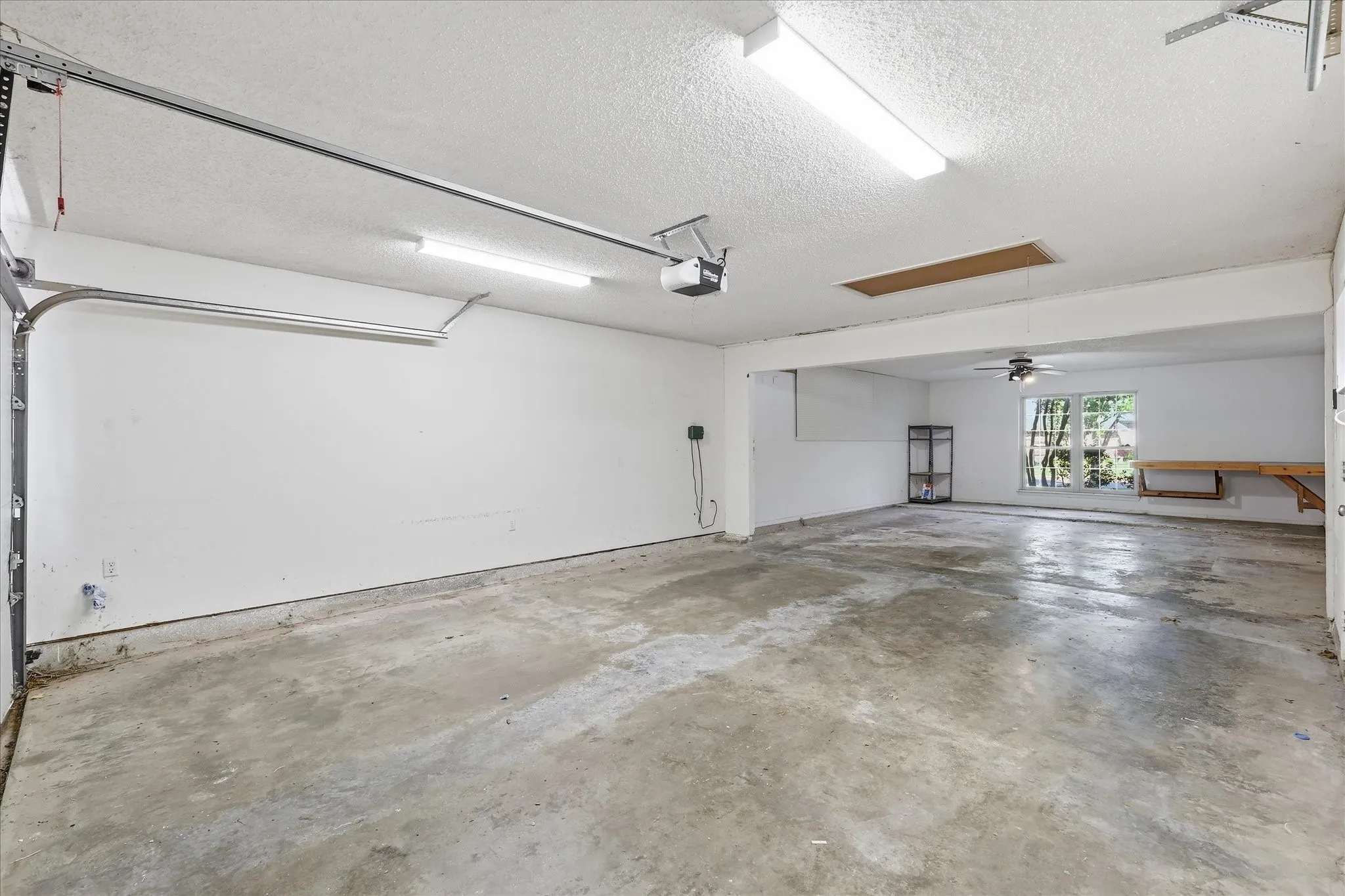 The expansive 4 car garage includes bright overhead lighting, built-in work surfaces and impressive flexibility for projects and storage.